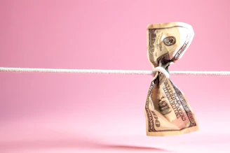 Dollar bill tied in a knot on a string