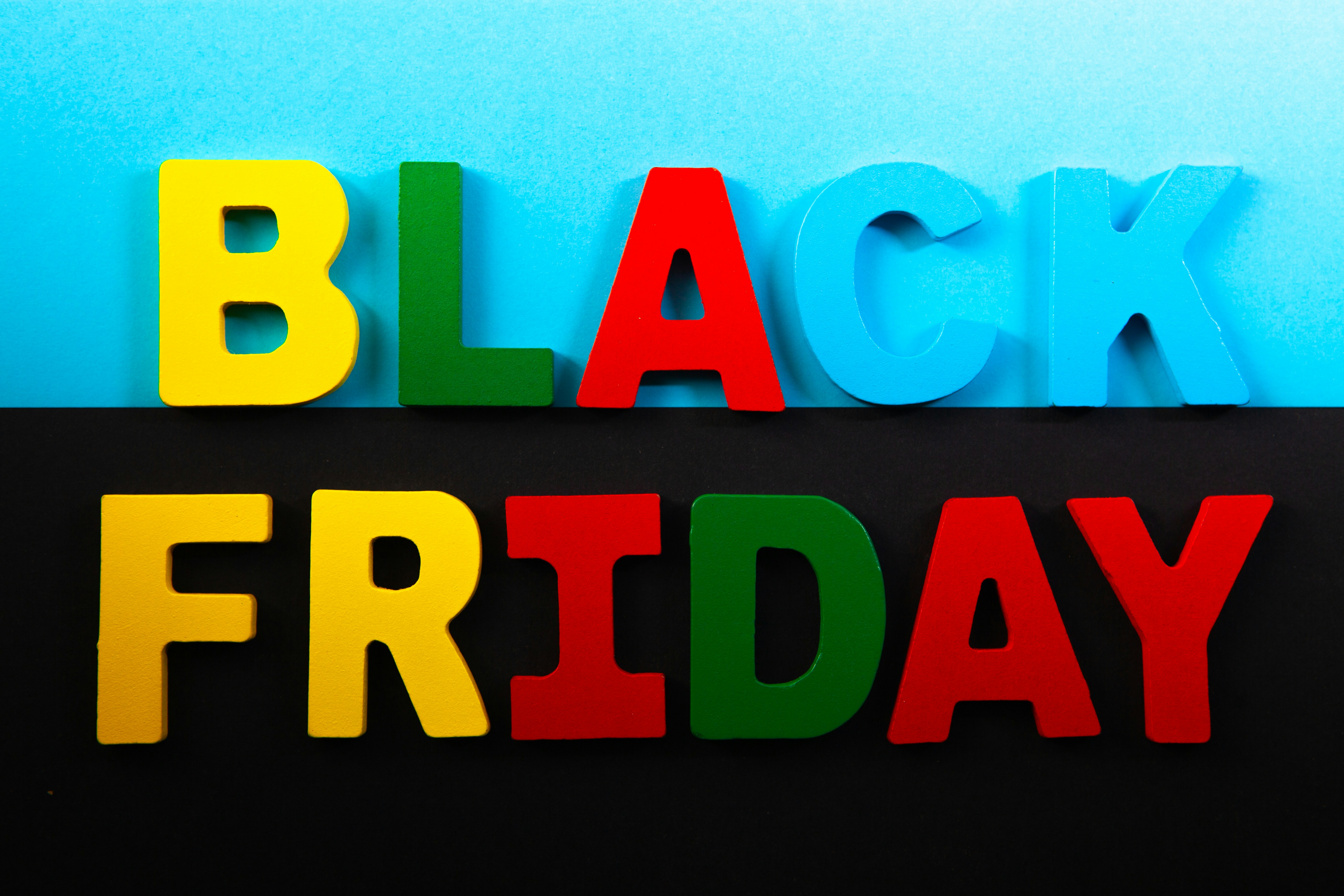 Colorful letters spelling "black friday" on backgrounds