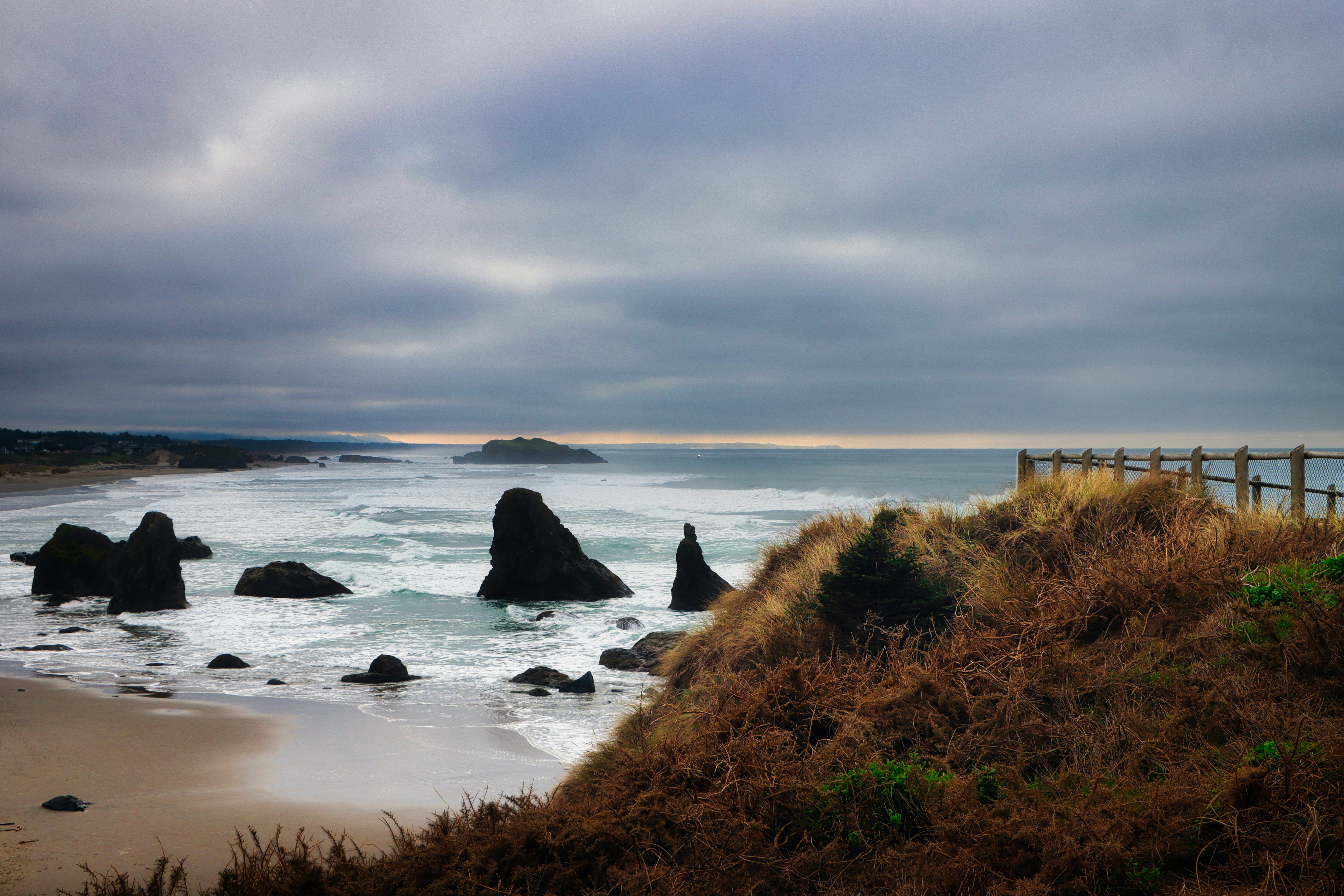Rocky coastline with waves crashing on a cloudy day