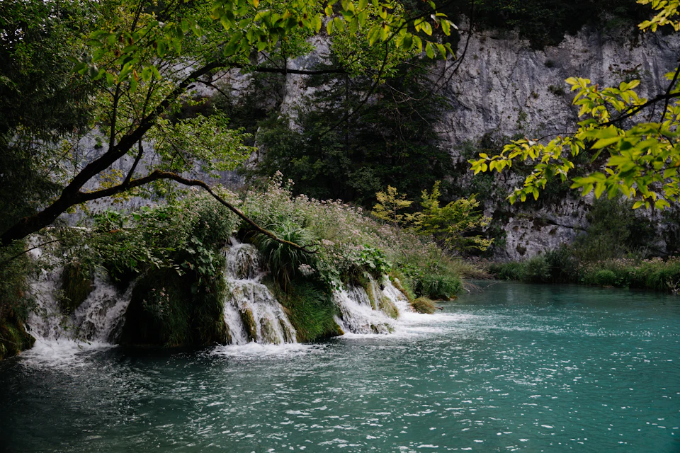 Waterfall cascading into a turquoise lake in Croatia