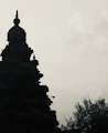 Silhouette of a temple against a cloudy sky