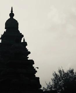 Silhouette of a temple against a cloudy sky