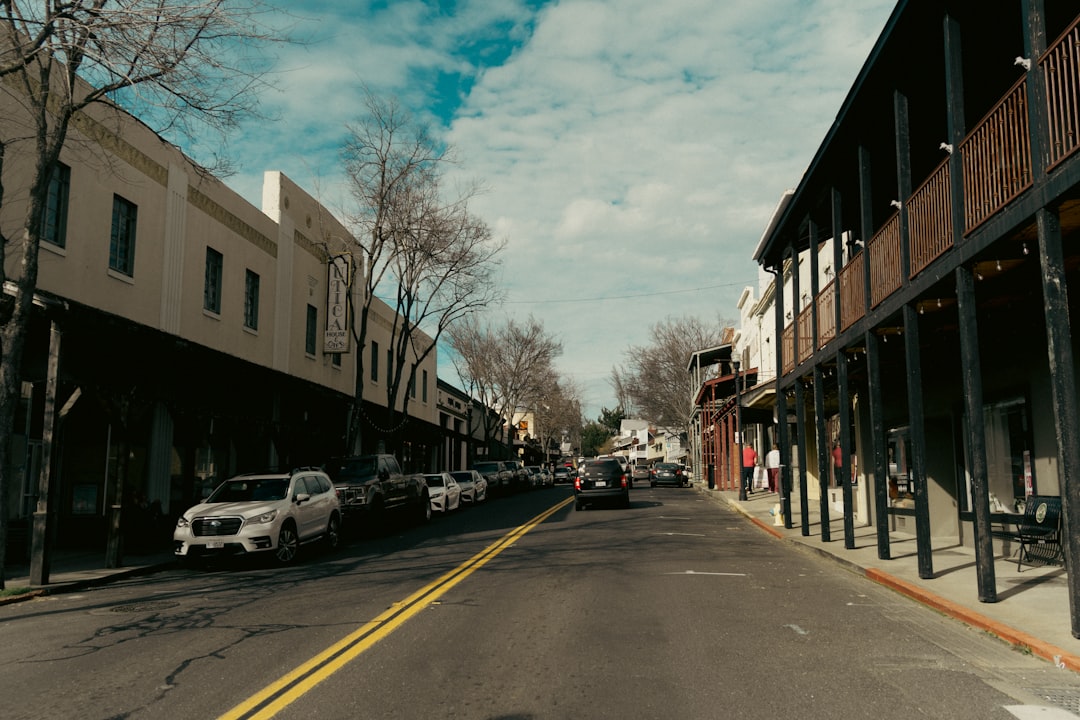 Street lined with buildings and parked cars