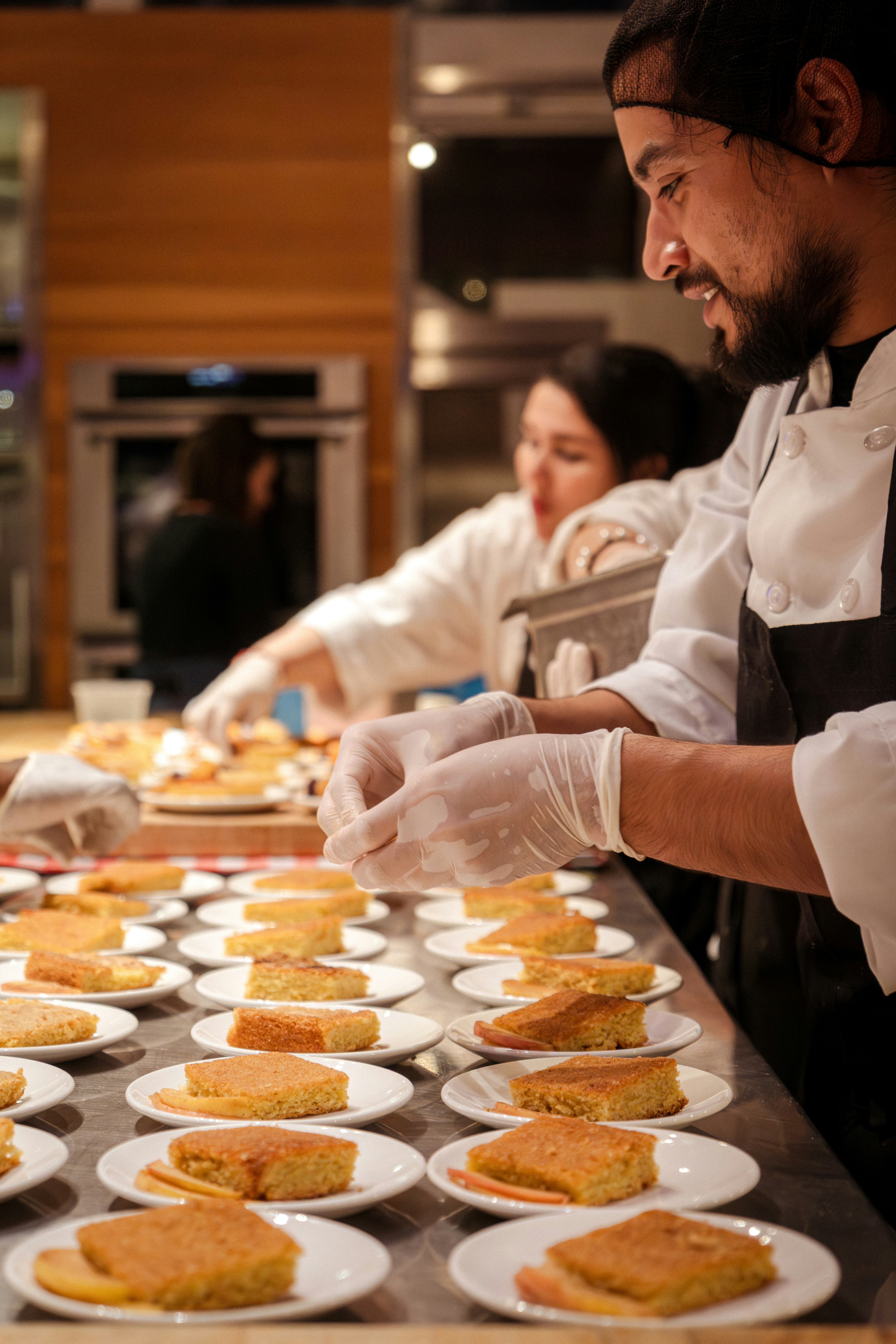 Chefs preparing food in a kitchen.
