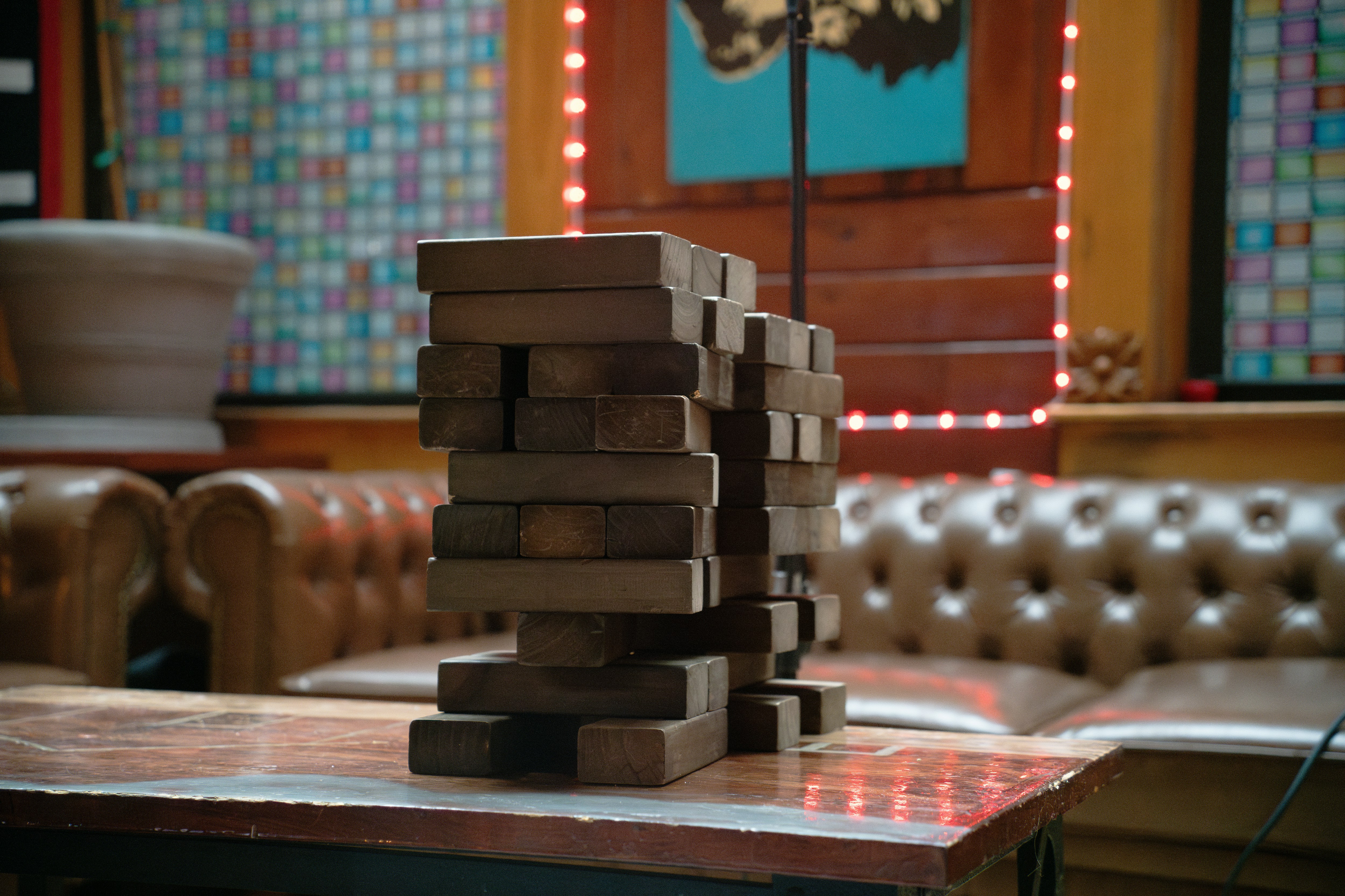 Wooden blocks stacked precariously on a table.
