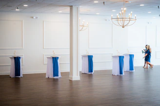 Empty event space with decorated high-top tables
