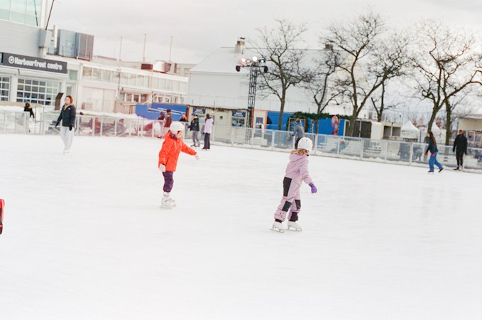 Young children in helmets learning to skate on an ice rink, like the kids in Las Vegas youth hockey programs who now have both an NHL and a PWHL team to follow
