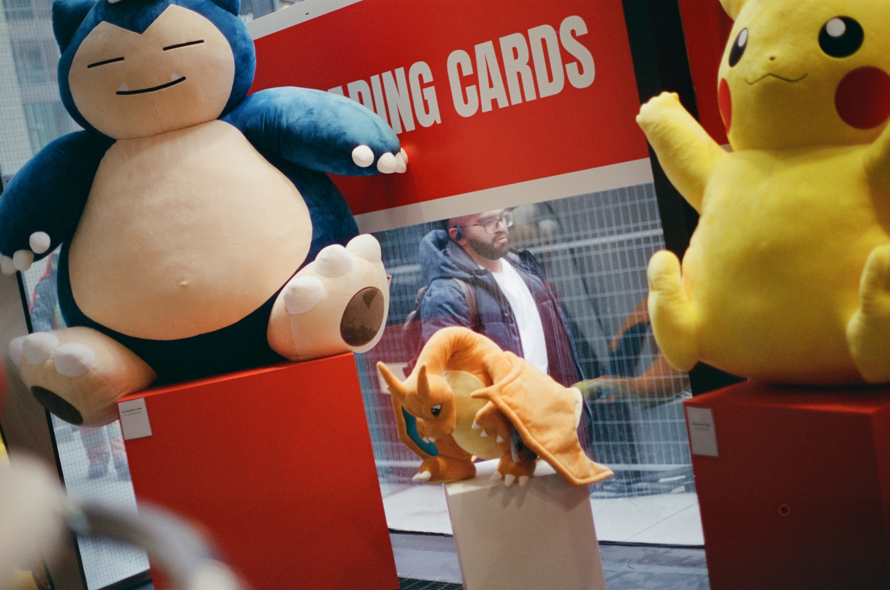 Snorlax, pikachu, and charizard plush toys displayed