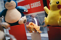 Snorlax, pikachu, and charizard plush toys displayed