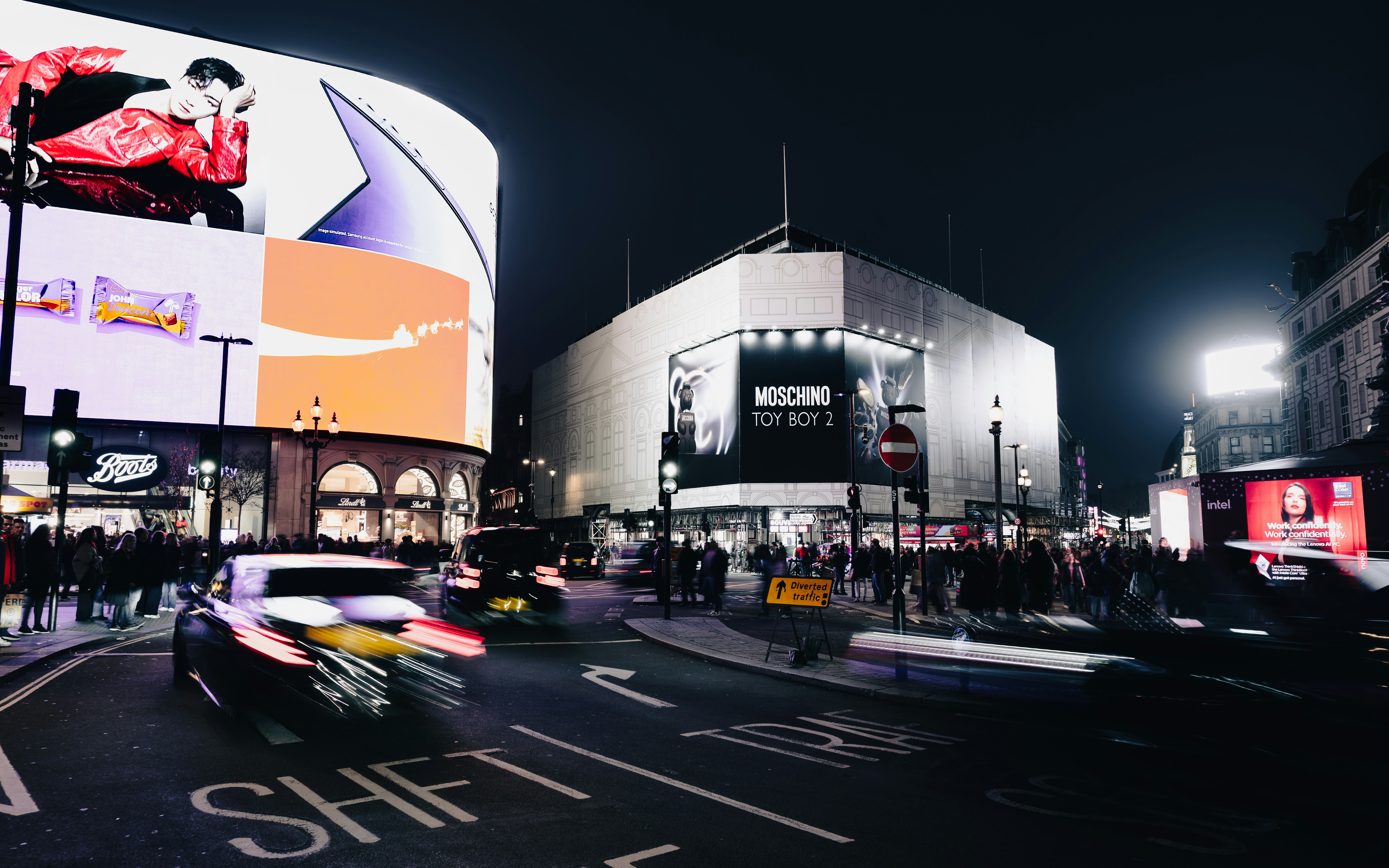Busy city street at night with bright lights