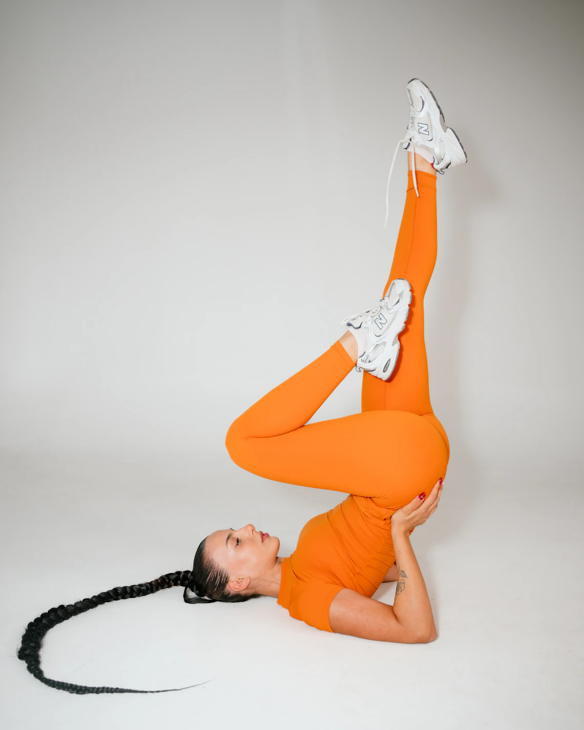 Woman practicing yoga in flexible modern activewear