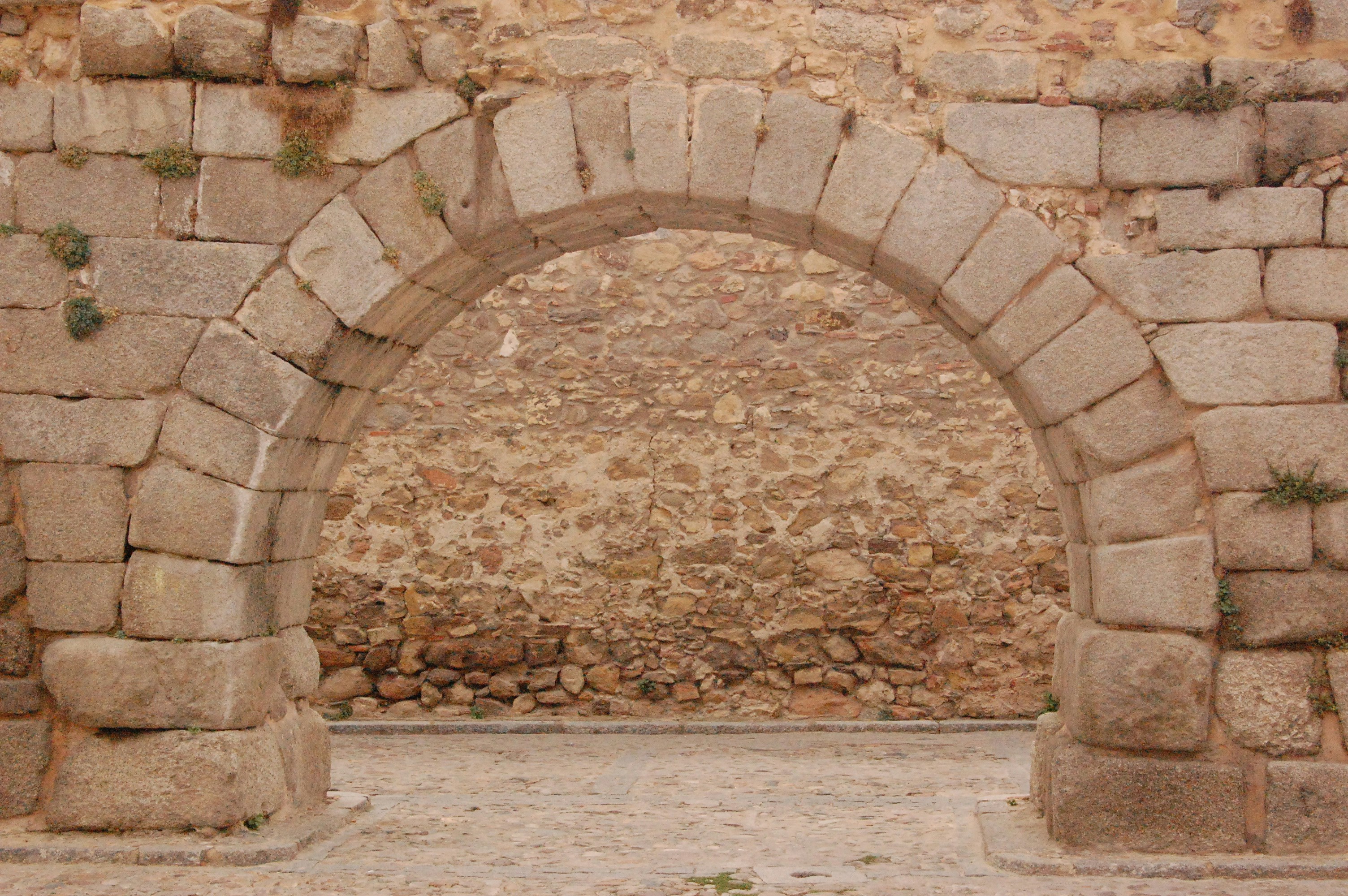 Stone archway in an ancient stone wall