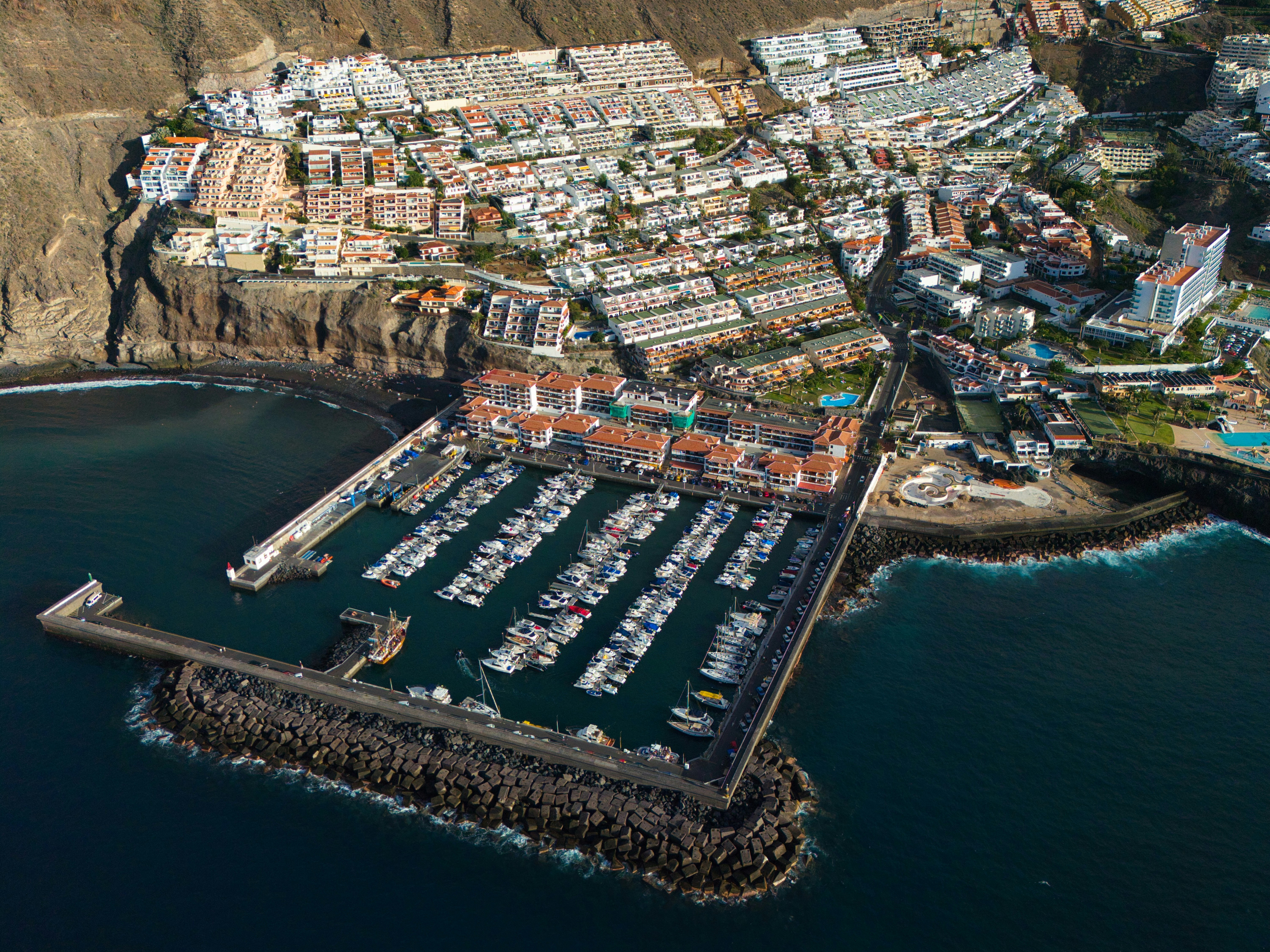 Aerial view of a marina with many boats docked
