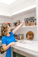 Woman organizing food in a well-stocked pantry