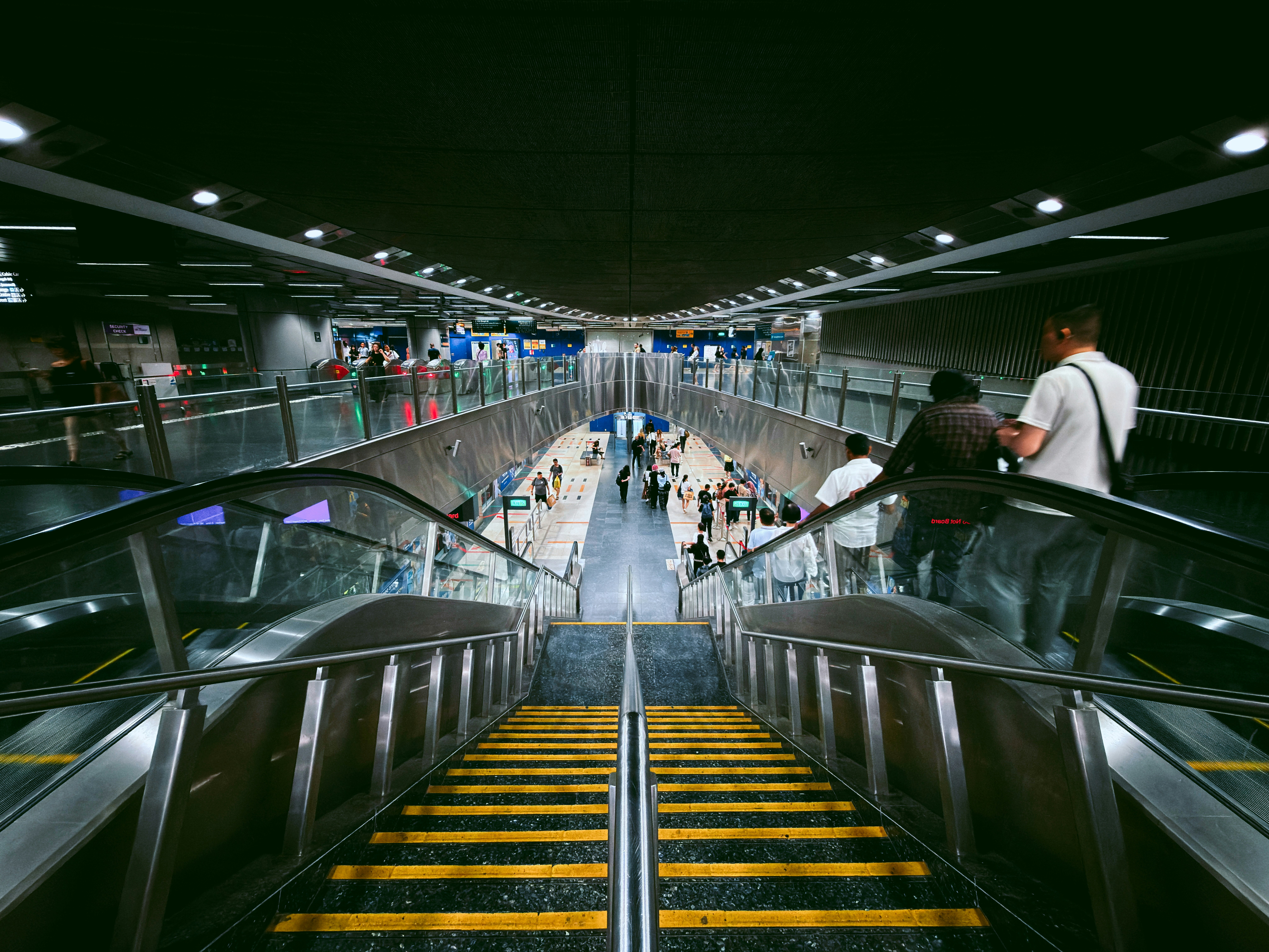 People on escalators in a modern subway station