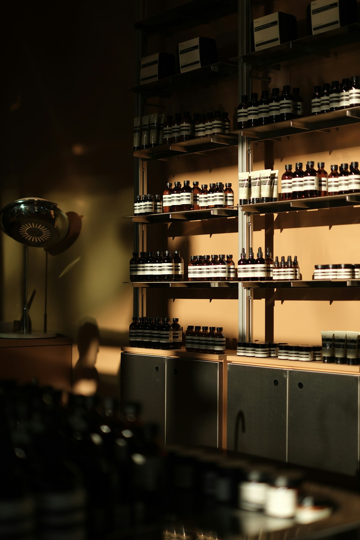 Rows of skincare product bottles arranged on retail shelves, the setting where a shopper's sense of whether a DTC brand's price feels fair gets formed