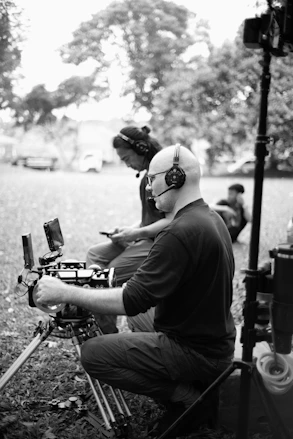 Two filmmakers operating camera equipment outdoors