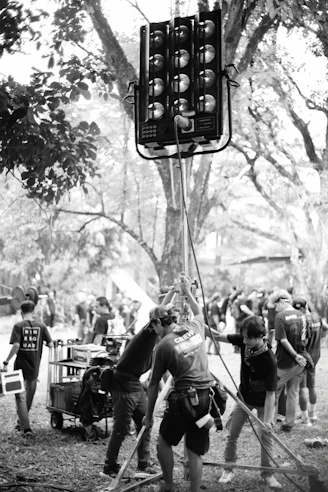 Film crew setting up a large light on location.