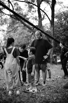 Director interacting with children on a film set outdoors