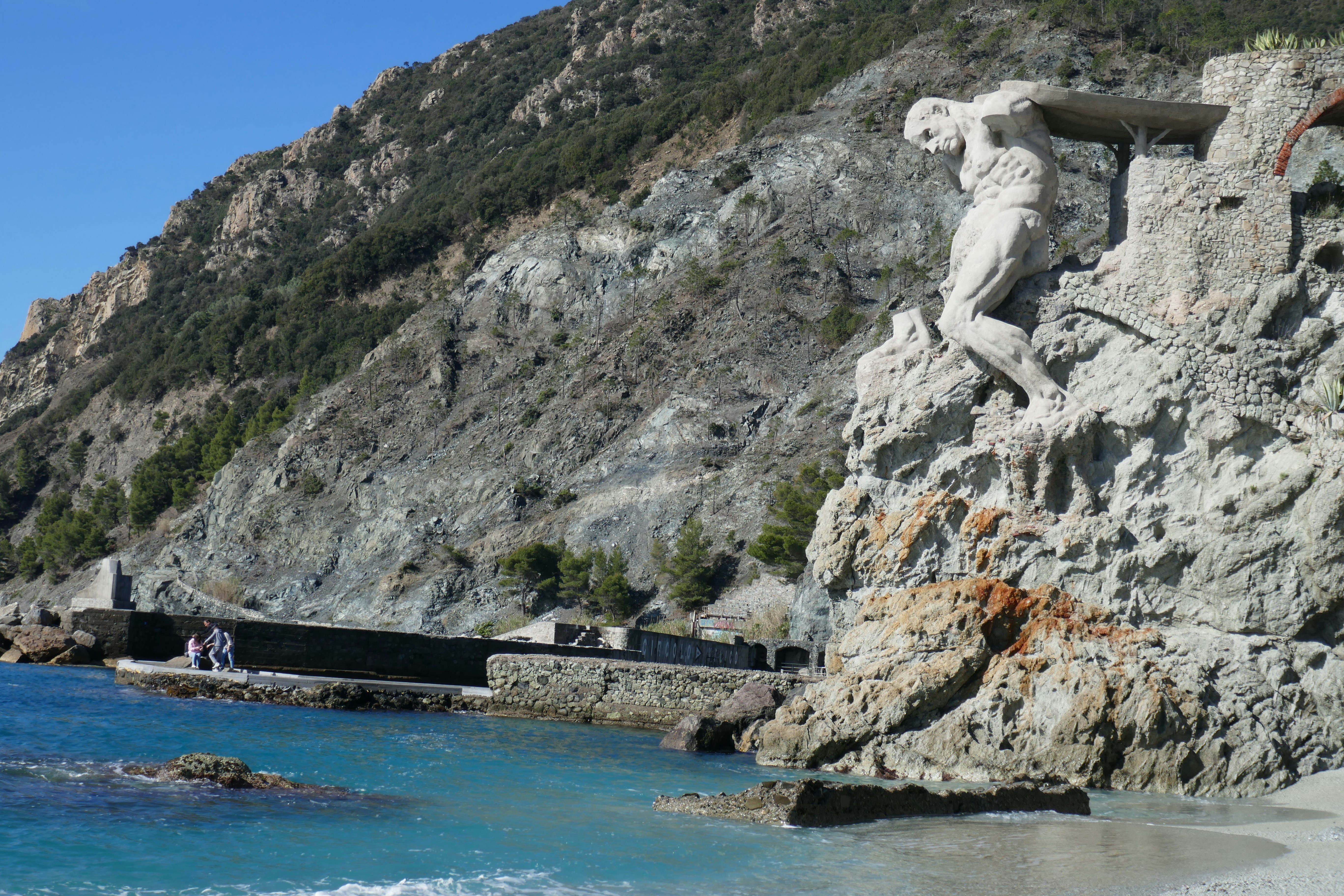 Bronze sculpture on a cliffside overlooking the sea