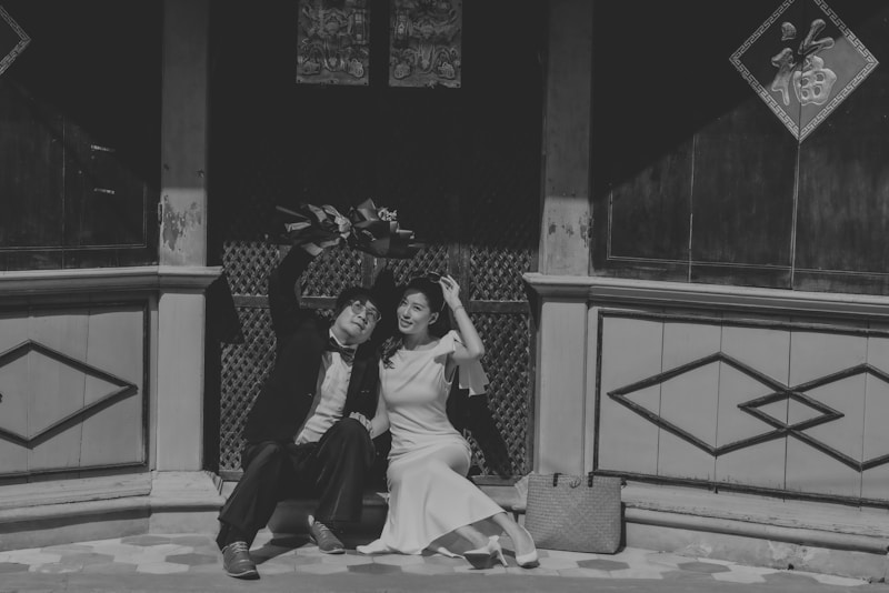 Happy couple celebrating with raised hands