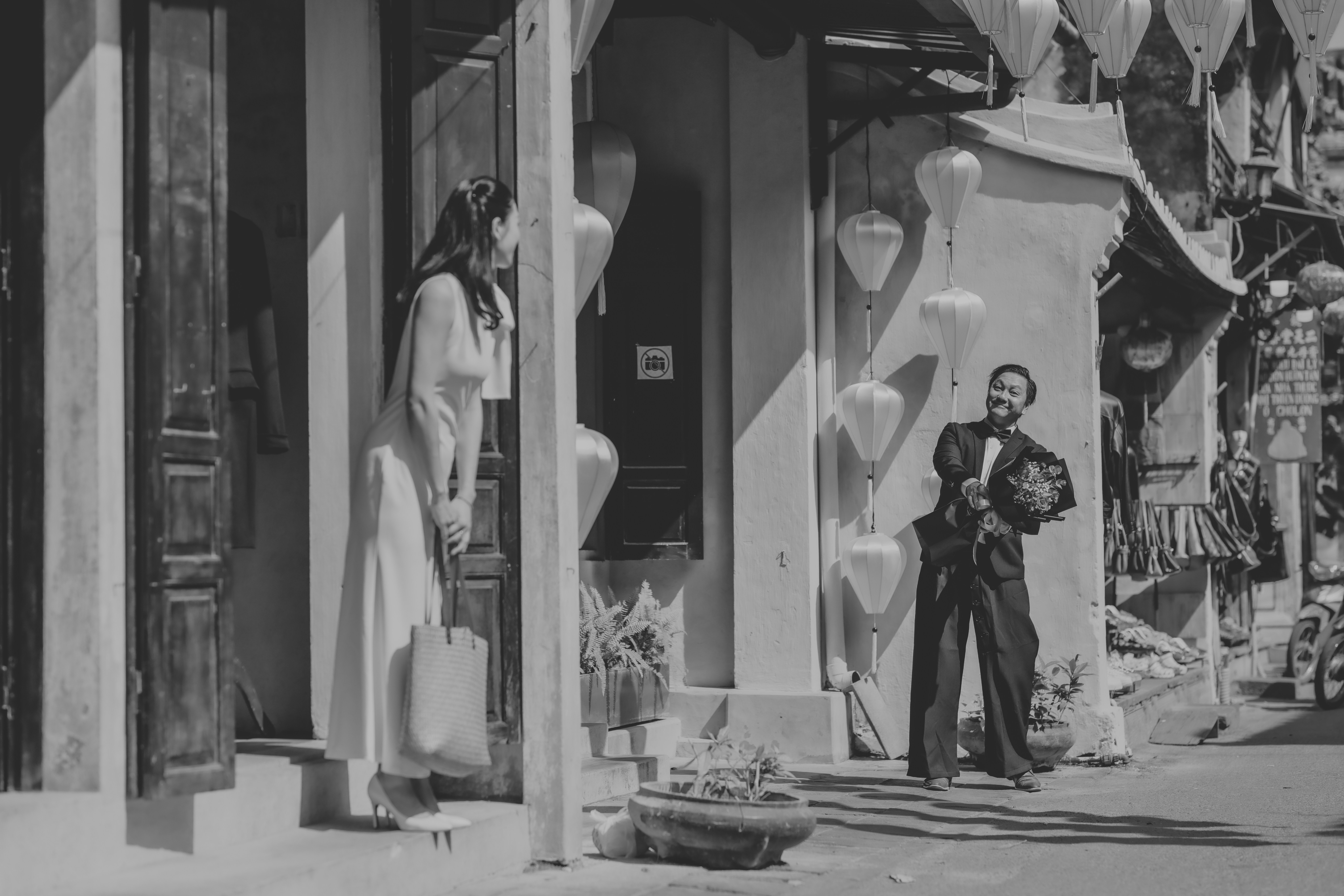 A man and woman interacting outside a building