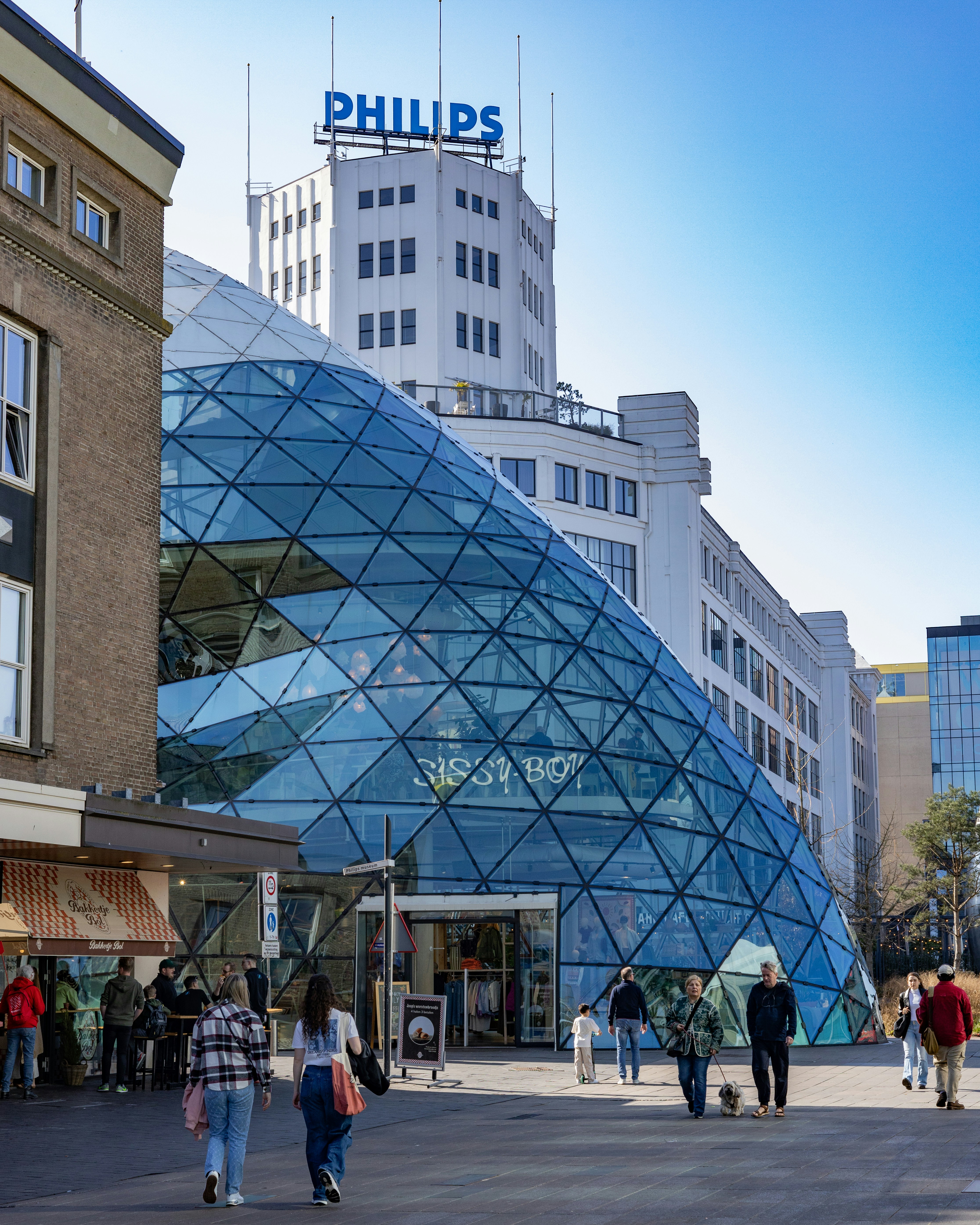 Modern glass building with philips sign in background