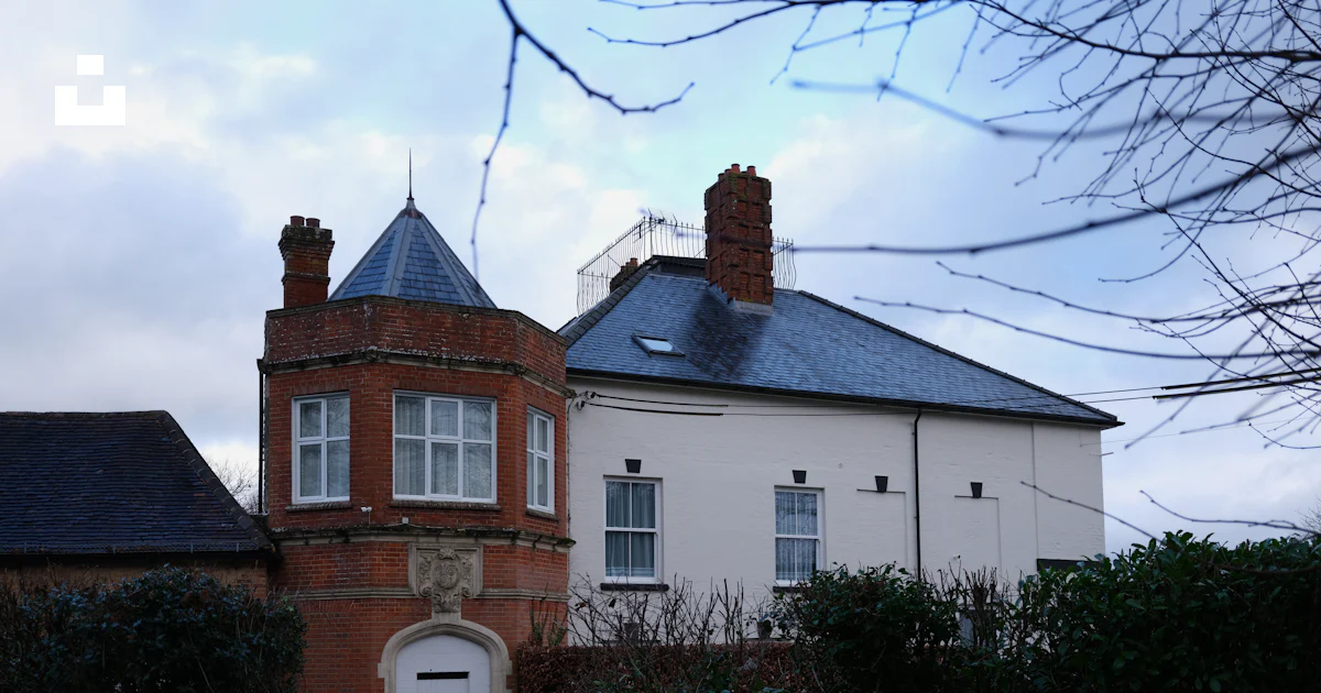 A brick building with a conical roof and white windows. photo – Free ...