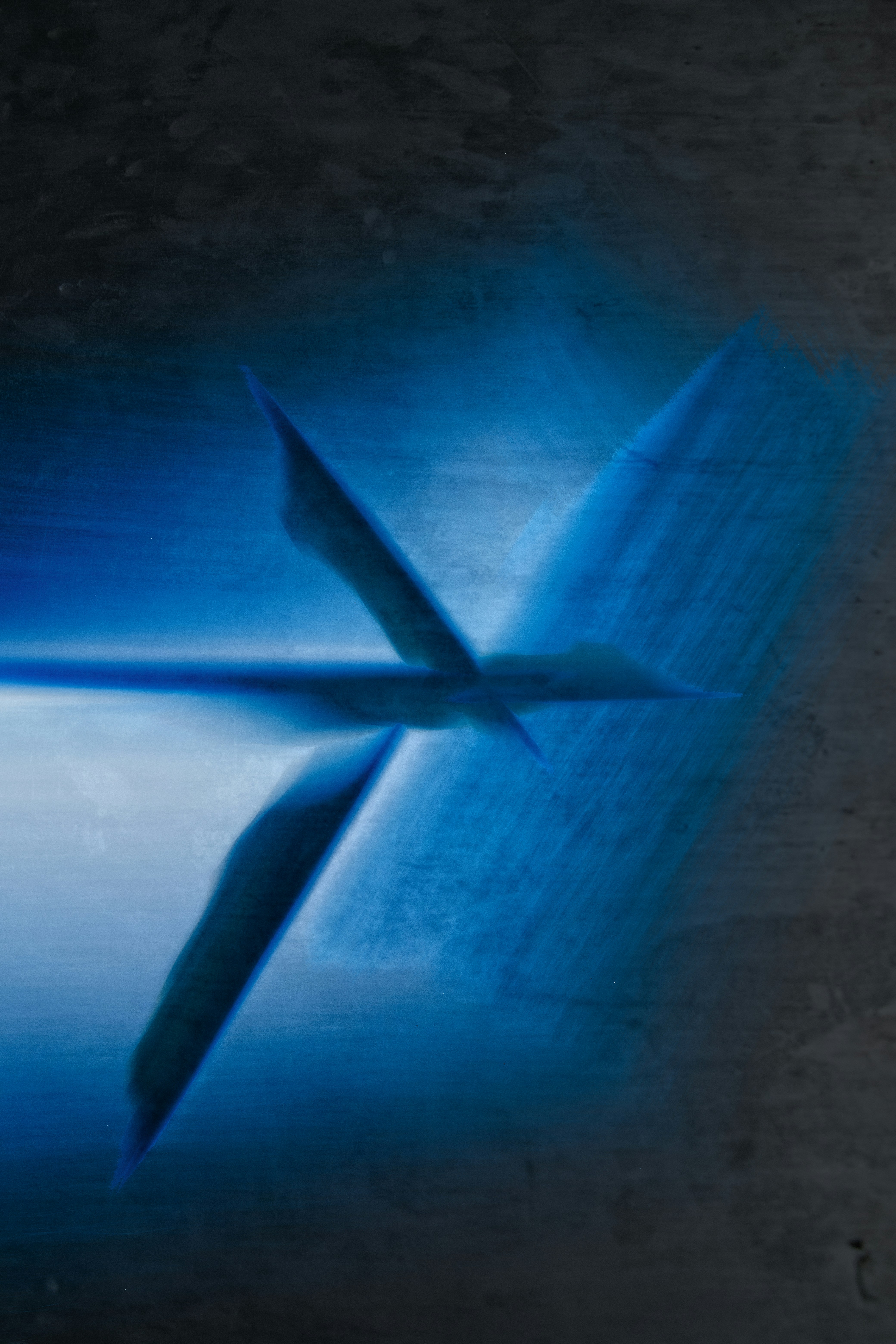 Abstract blue light streaks across a dark background