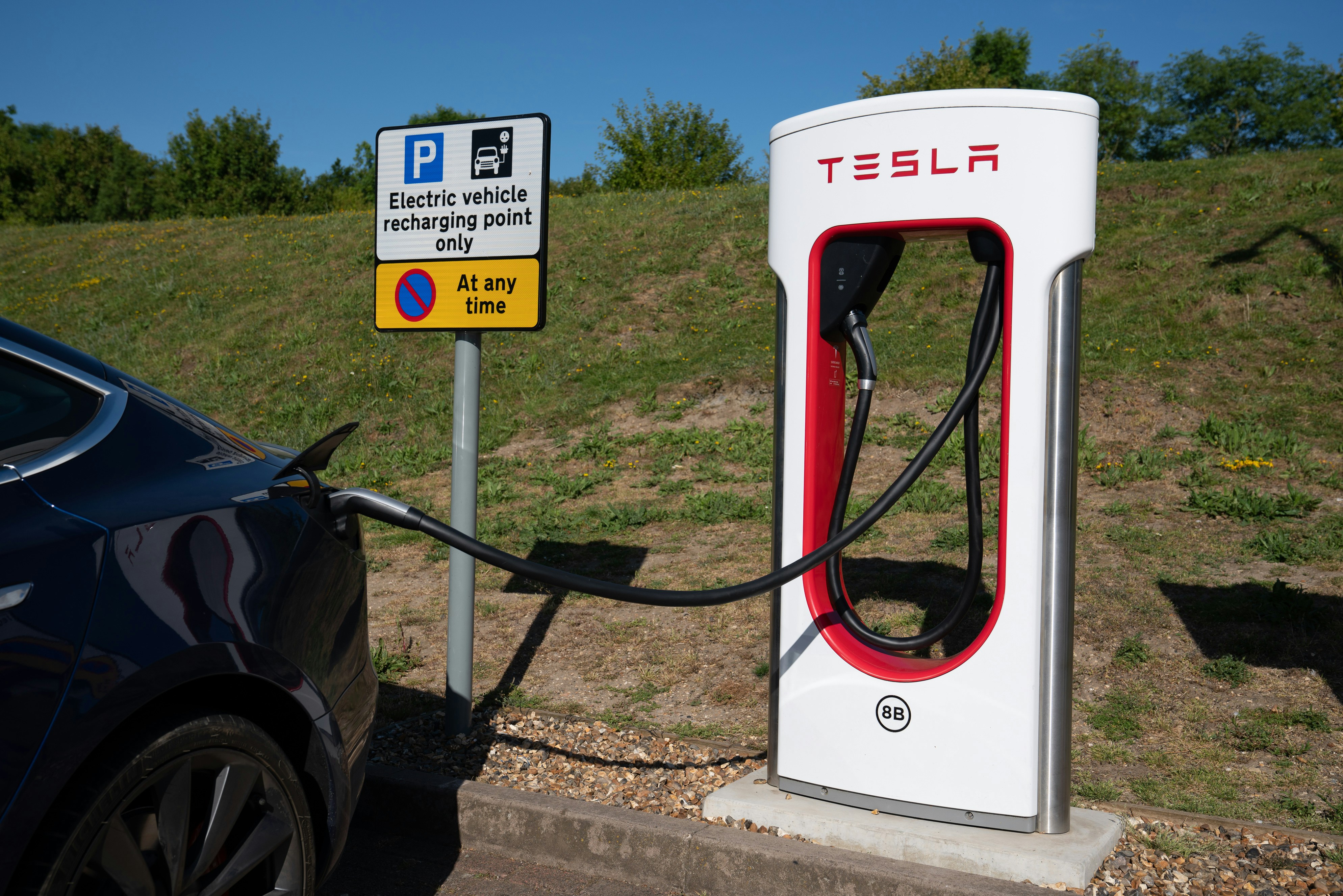Tesla charging station with electric car connected.