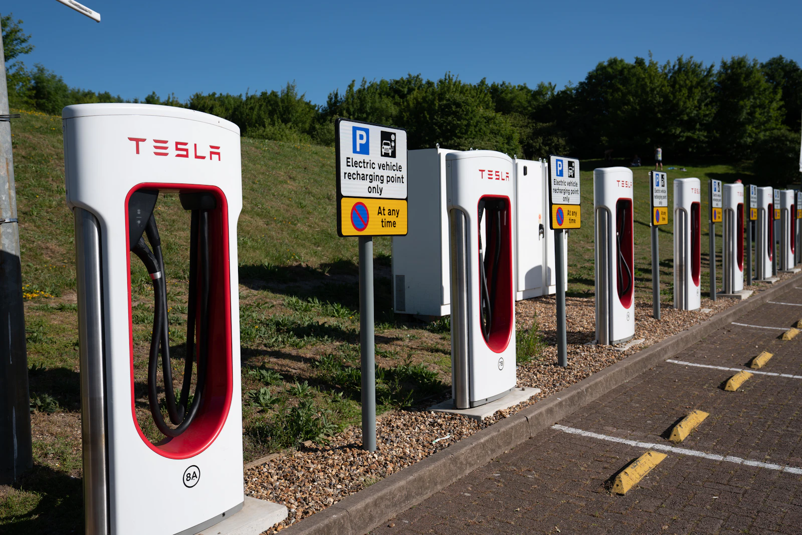 An EV charging station stands beside a road