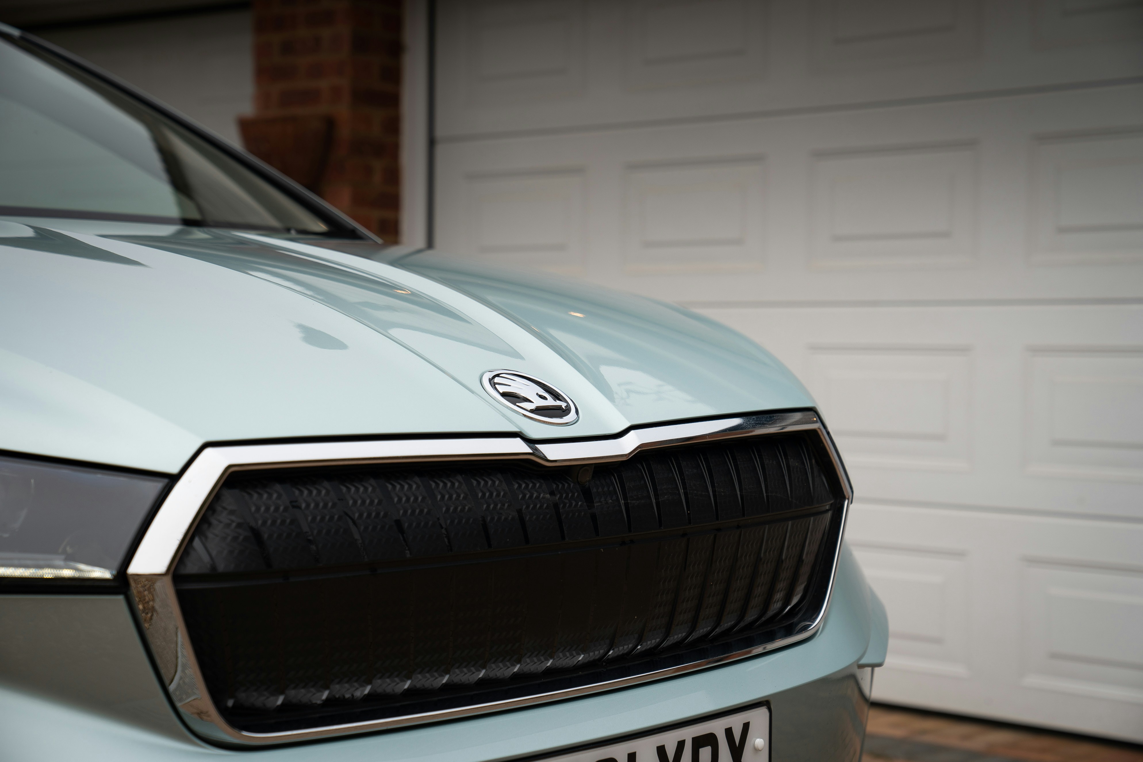 Skoda Enyaq electric SUV - Close-up of a modern car's front grille and logo.