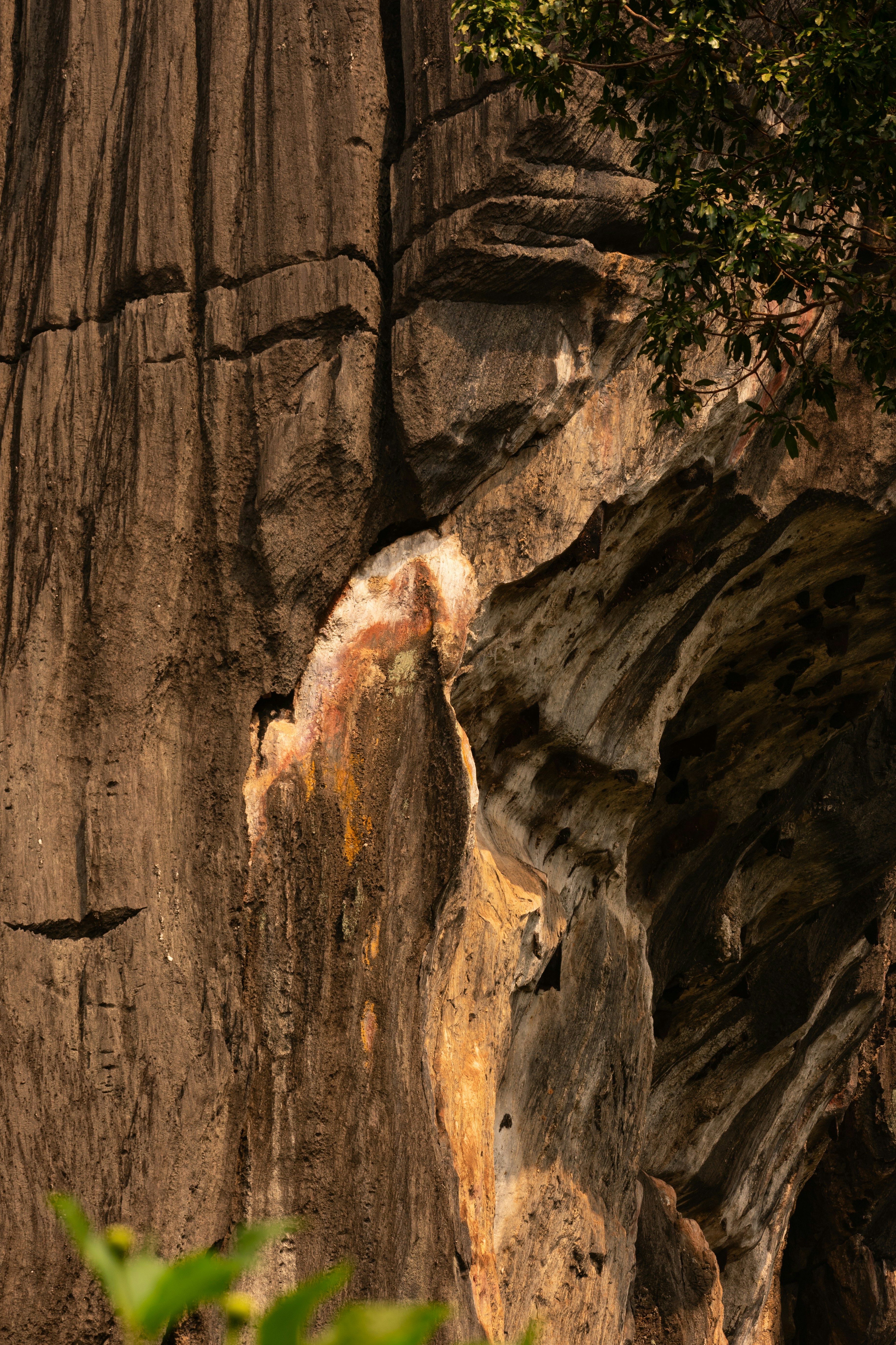 Close up of weathered rock formation with colorful mineral deposits