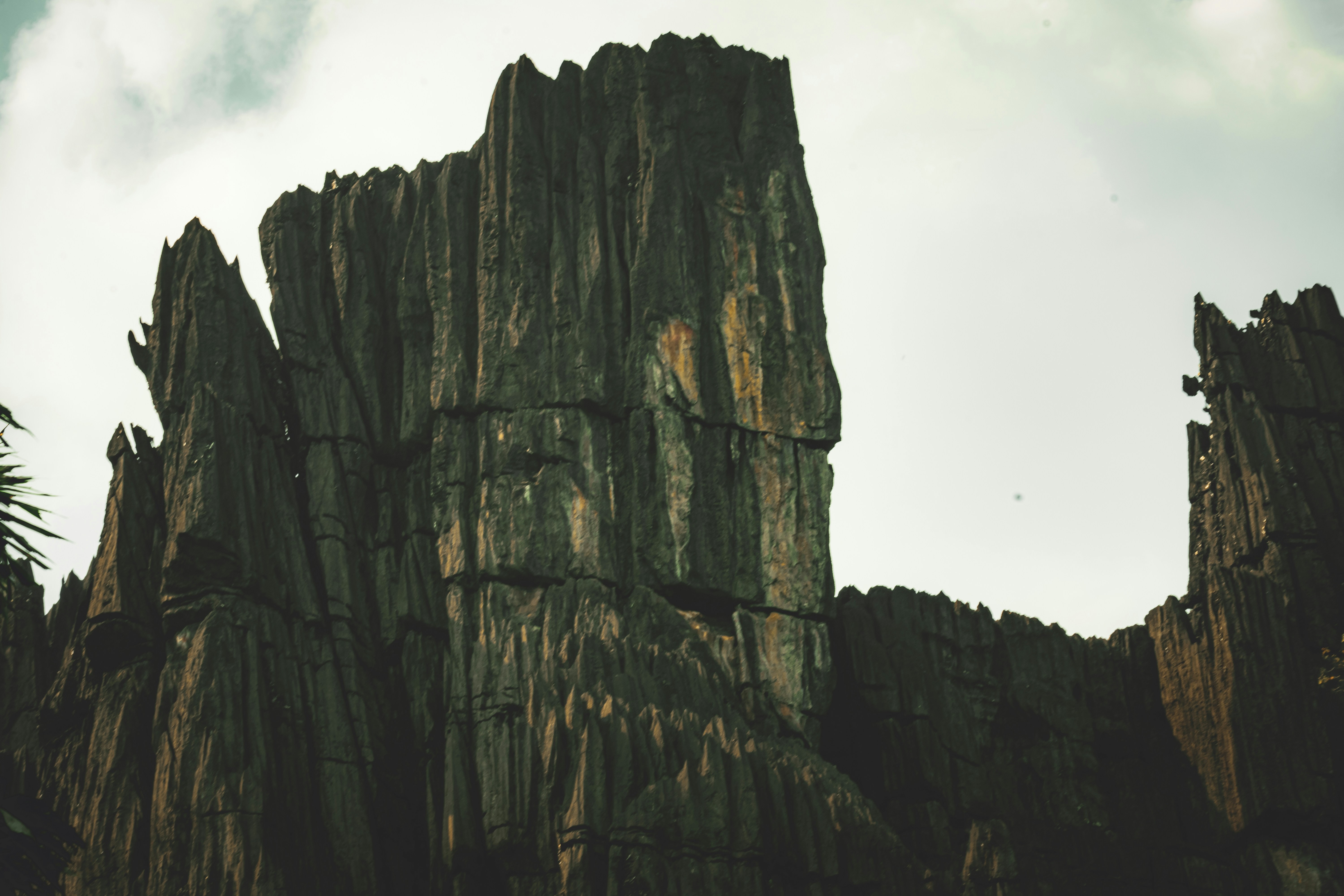 Tall, jagged rock formations against a cloudy sky