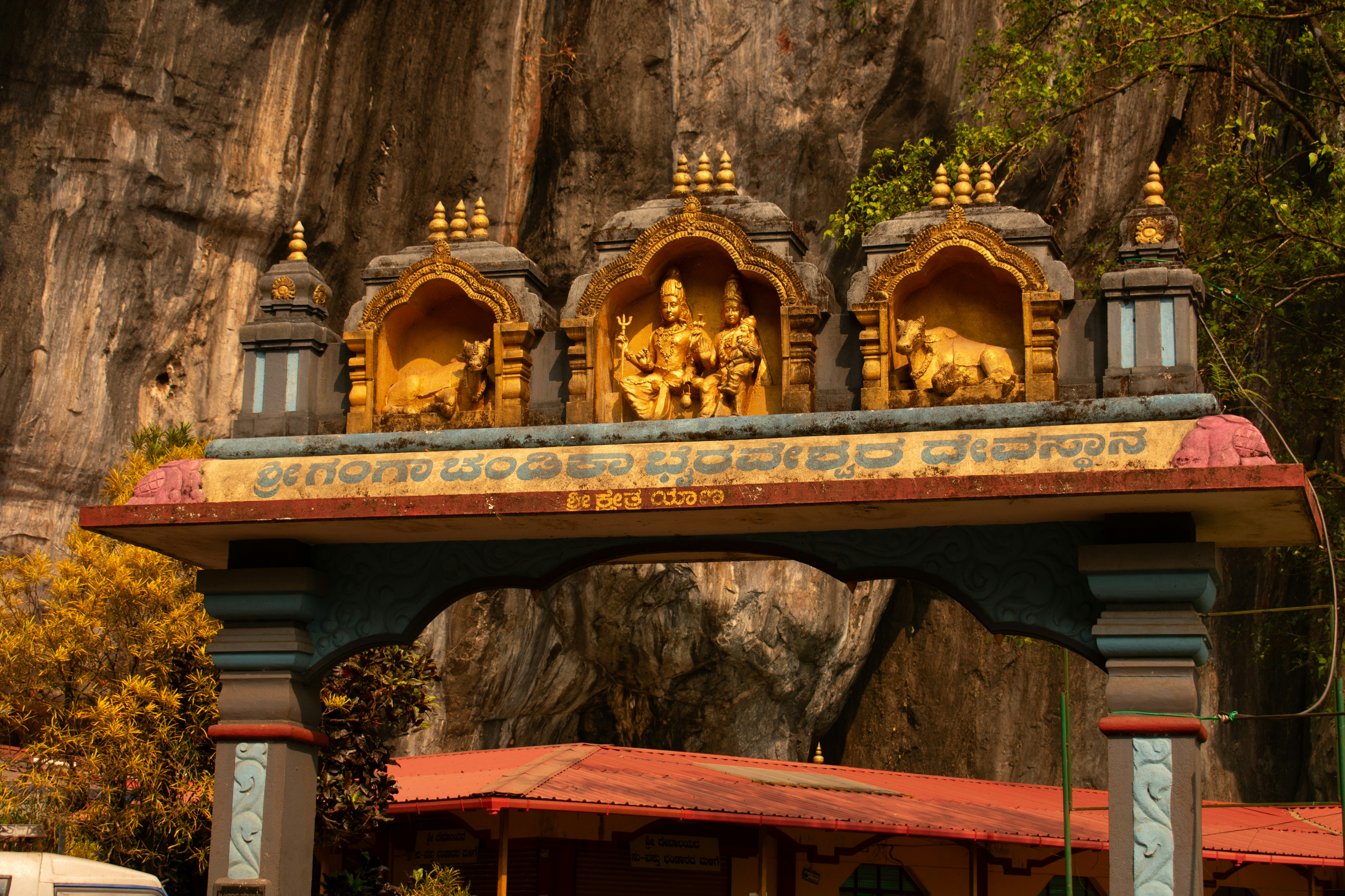 Ornate golden archway with religious carvings and architectural details.
