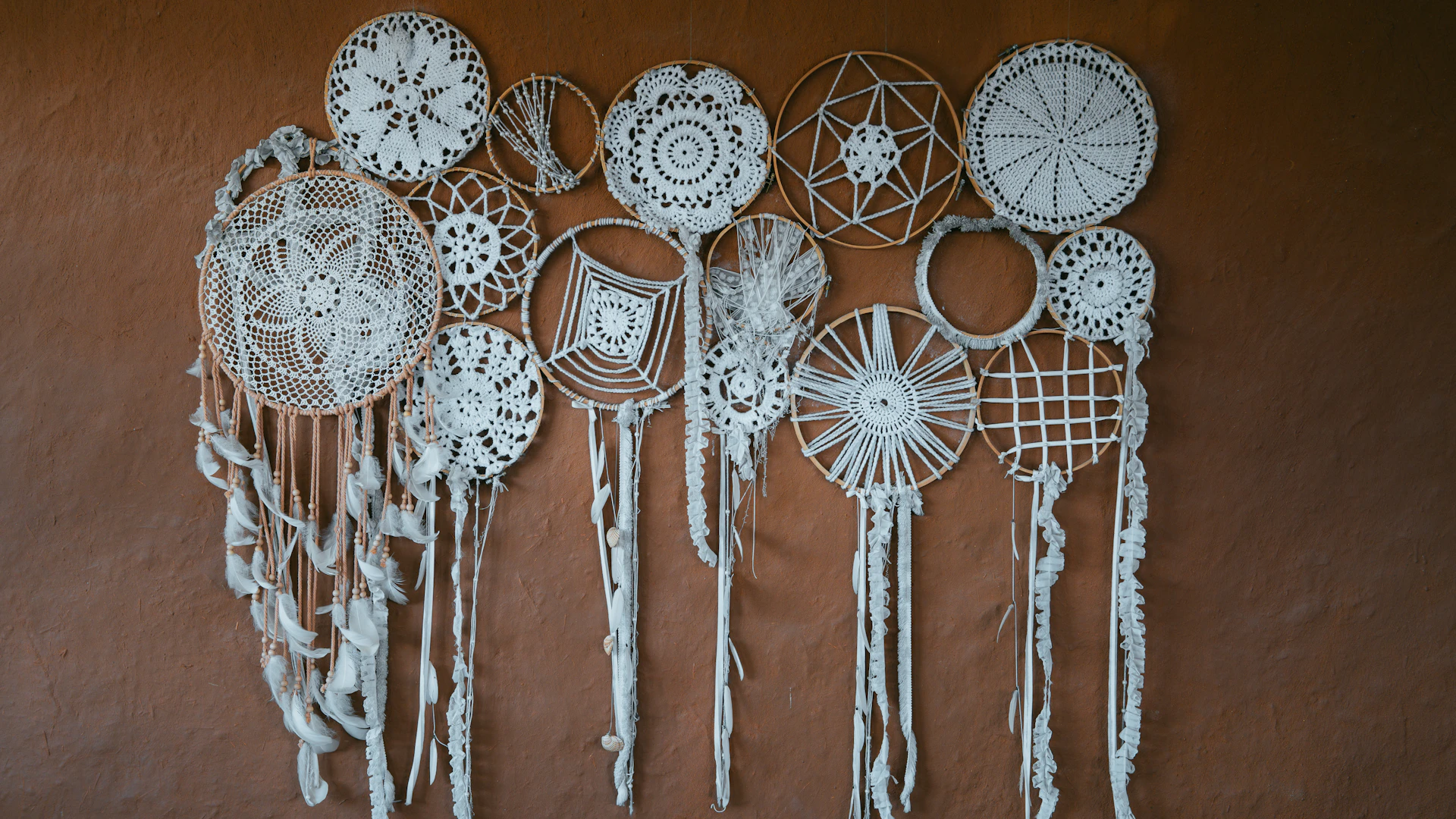 Collection of white dreamcatchers hanging on a wall