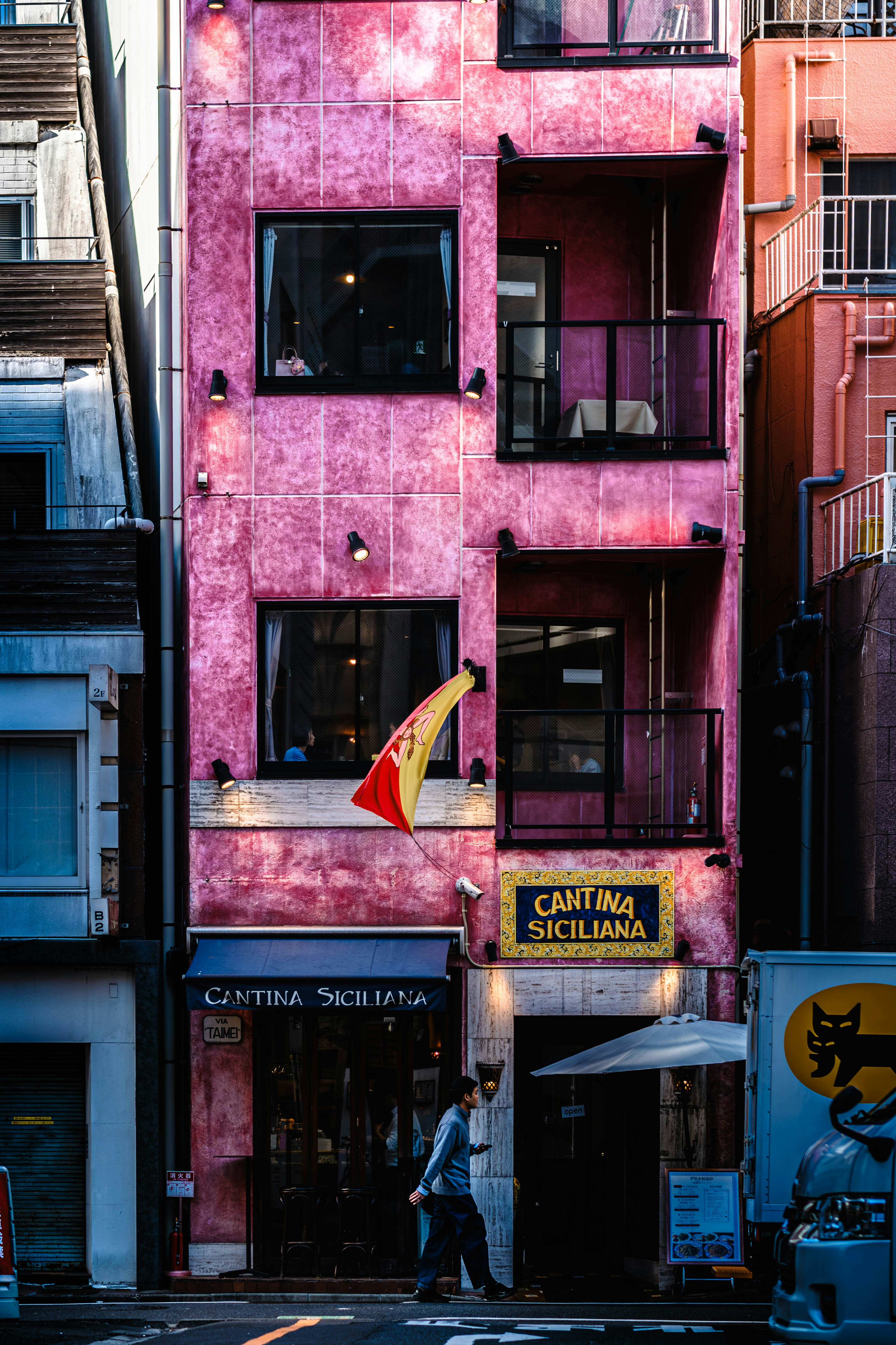 Pink building with "cantina siciliana" signs