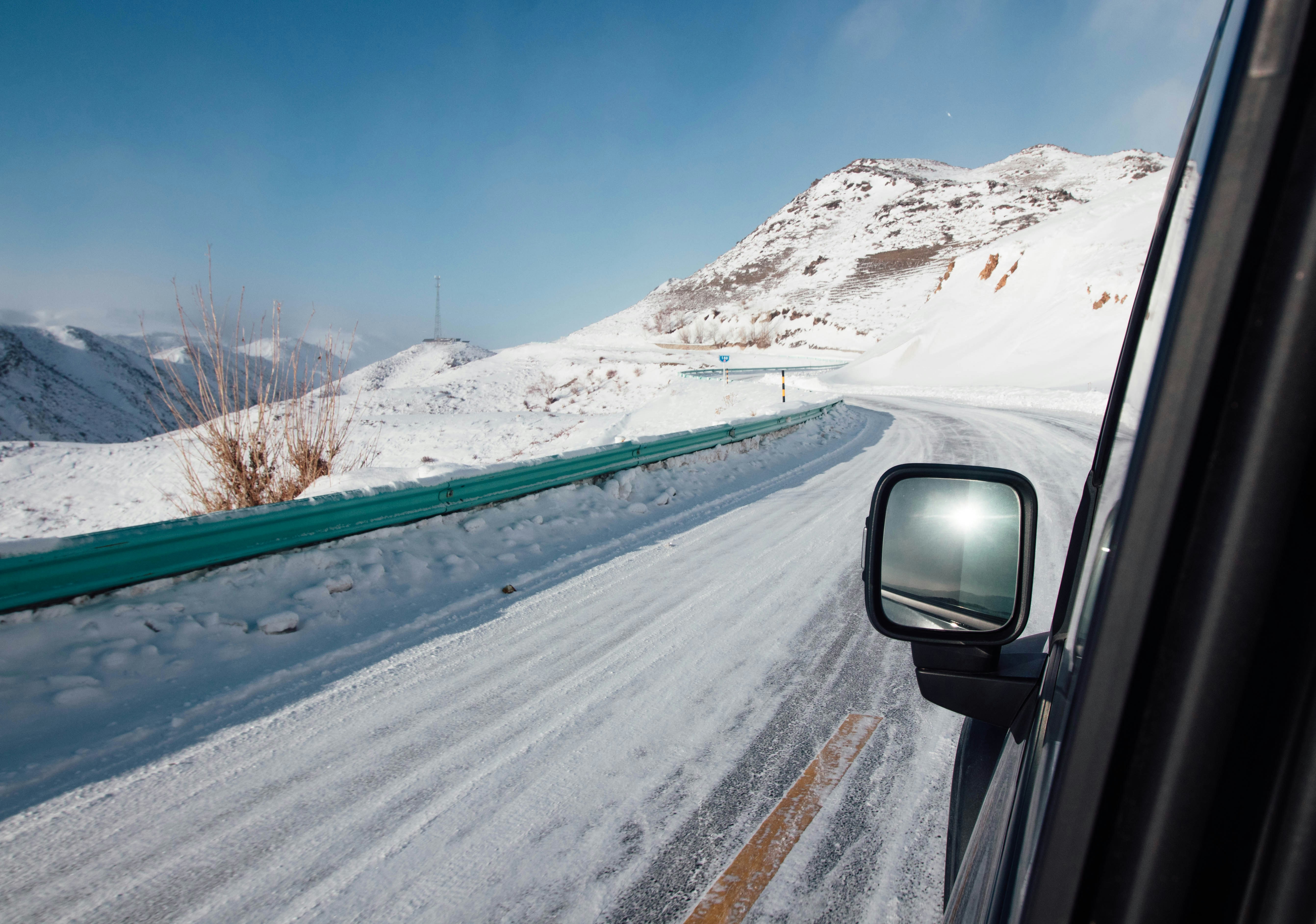 Driving on a snowy mountain road in winter.