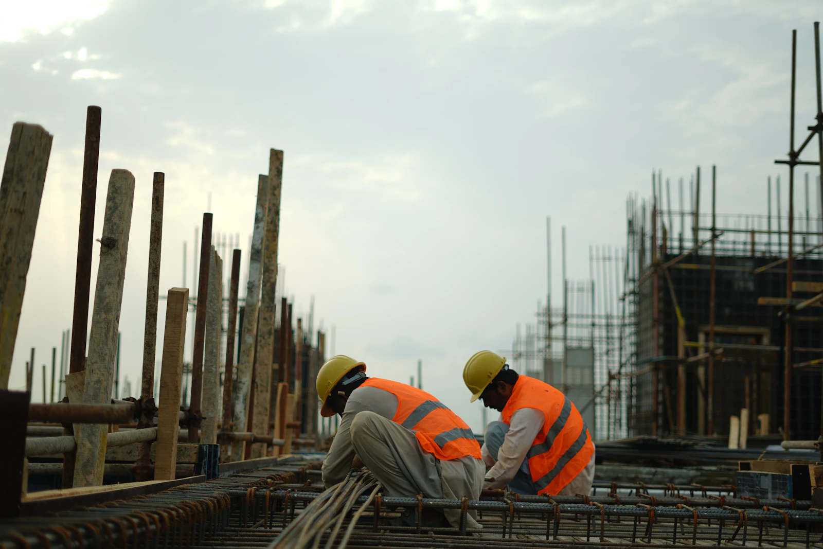 Workers in safety vests at an industrial site