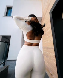 Woman in white athletic wear posing outdoors