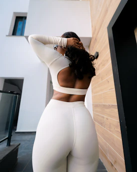 Woman in white athletic wear posing outdoors