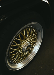 Close-up of a gold and silver car wheel