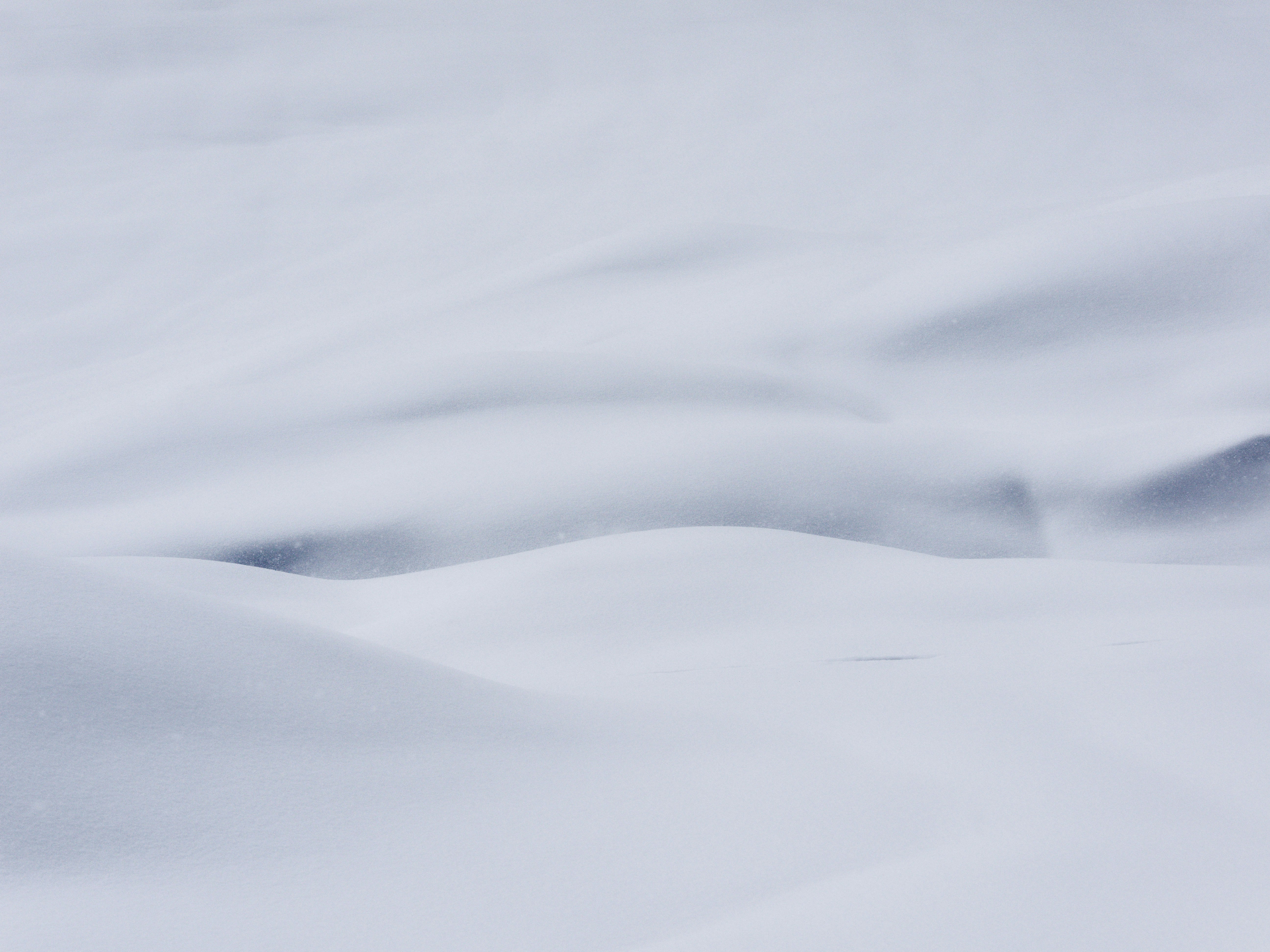 Abstract snow drifts with subtle blue shadows