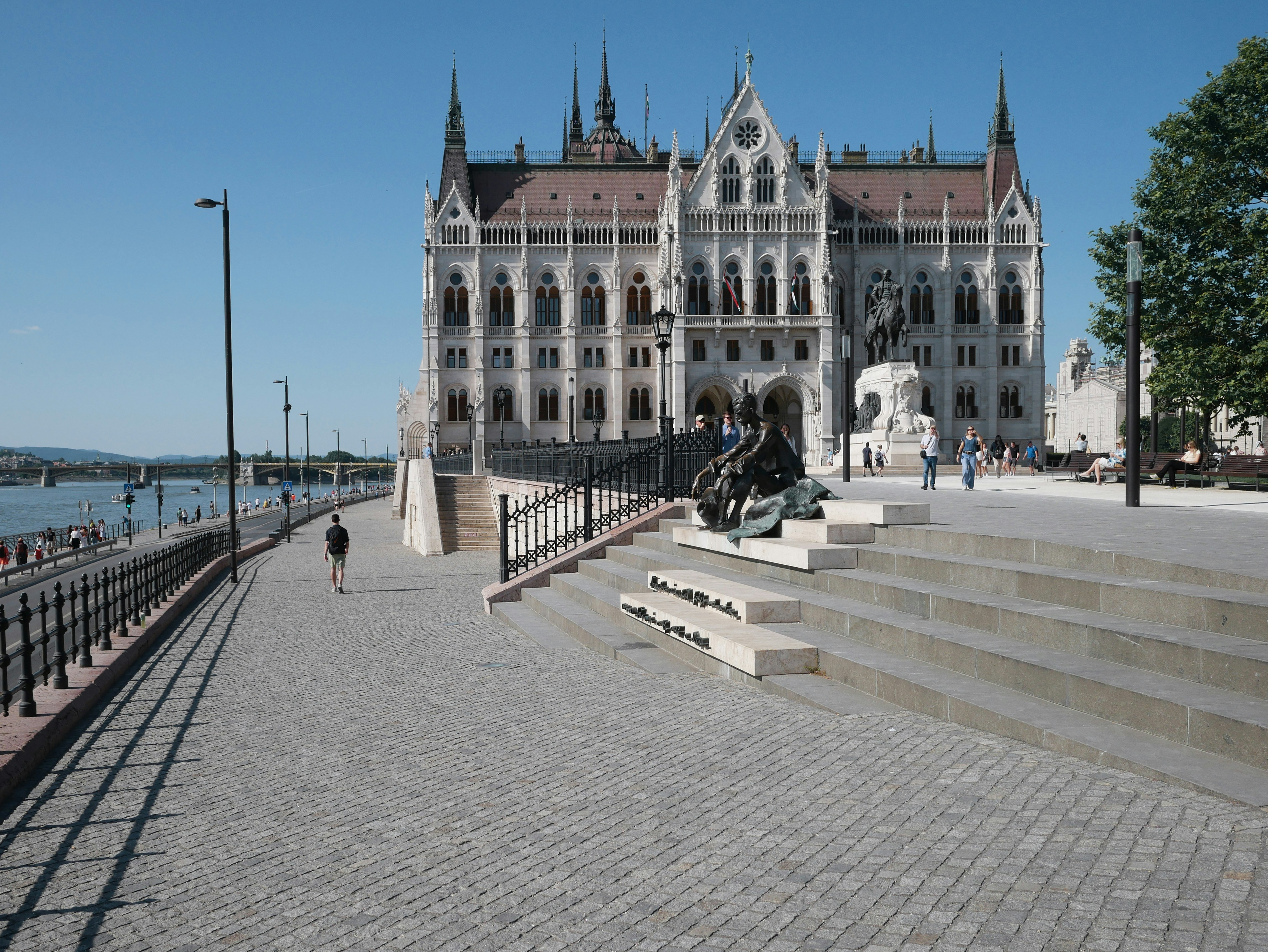 Ornate building with a river and paved walkway
