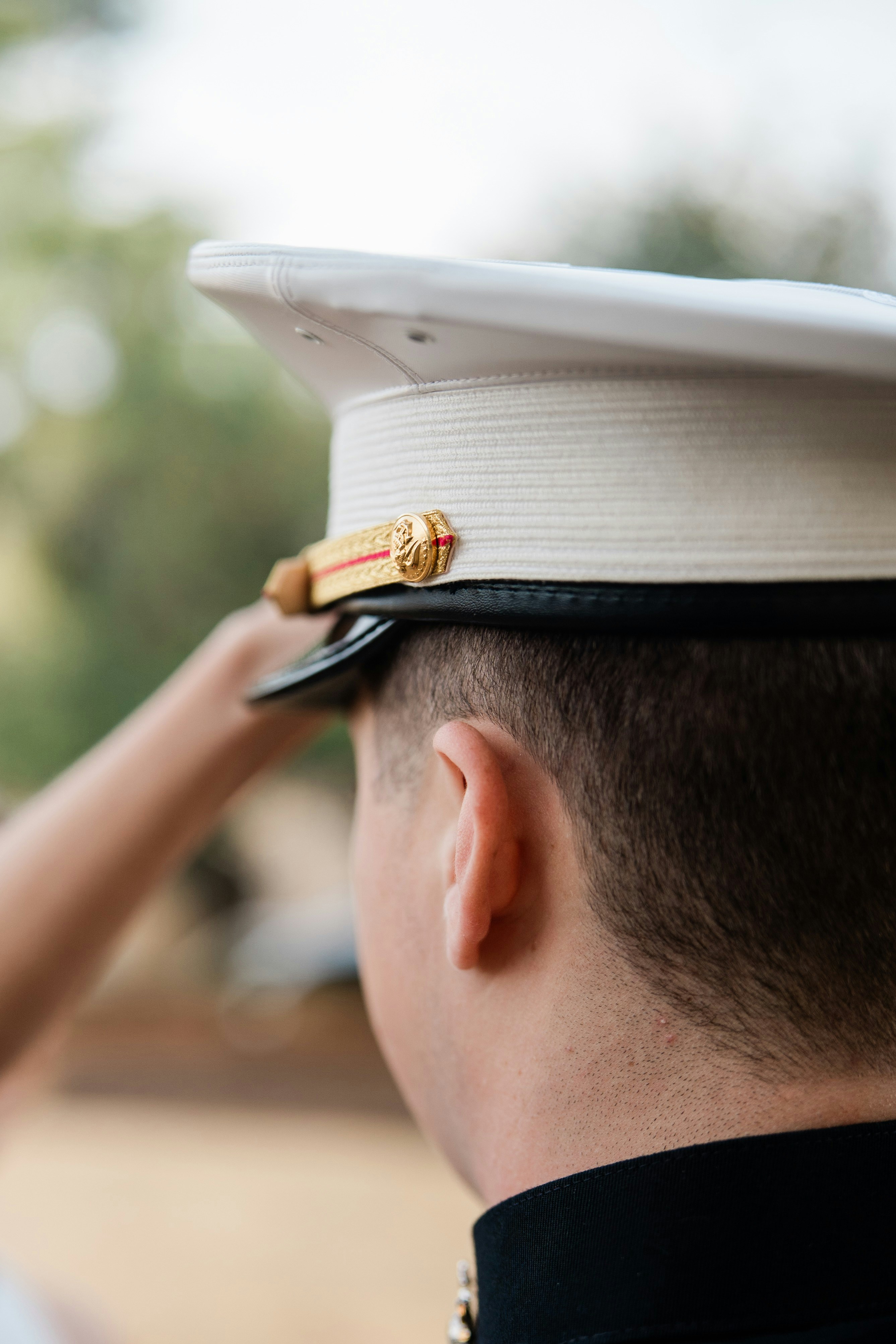 A person in a military uniform salutes.