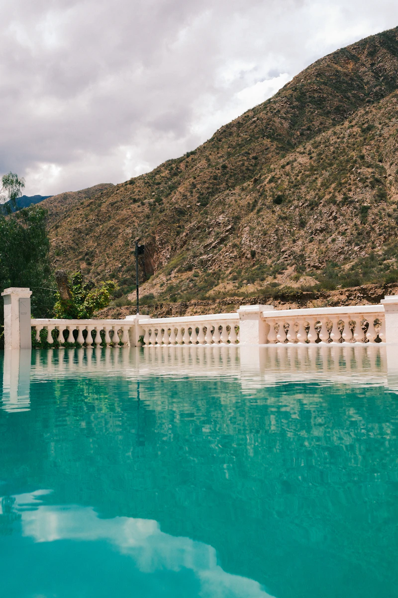 Infinity edge pool with mountain view and stone balustrade