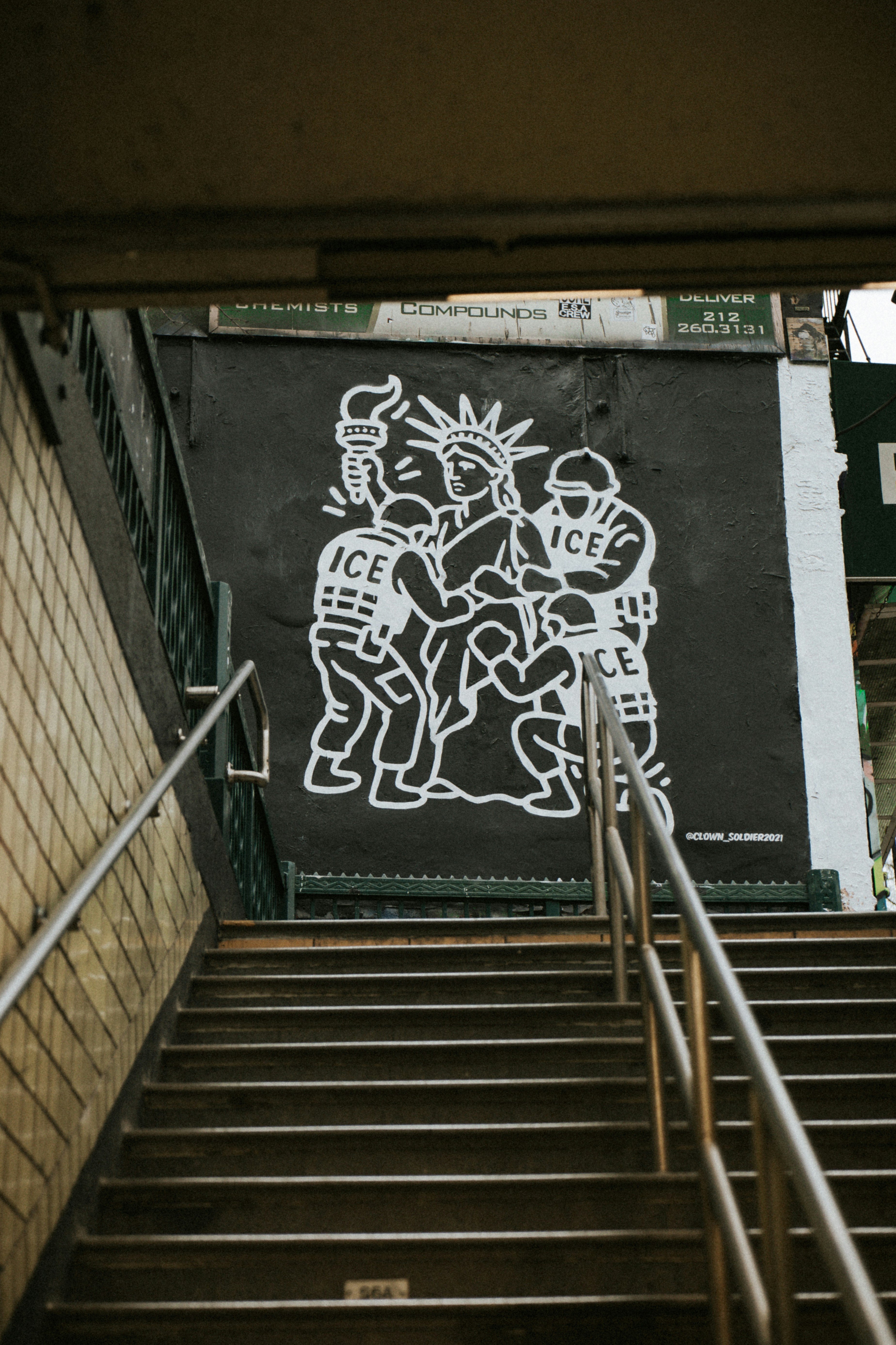 Street art mural of statue of liberty with ice agents