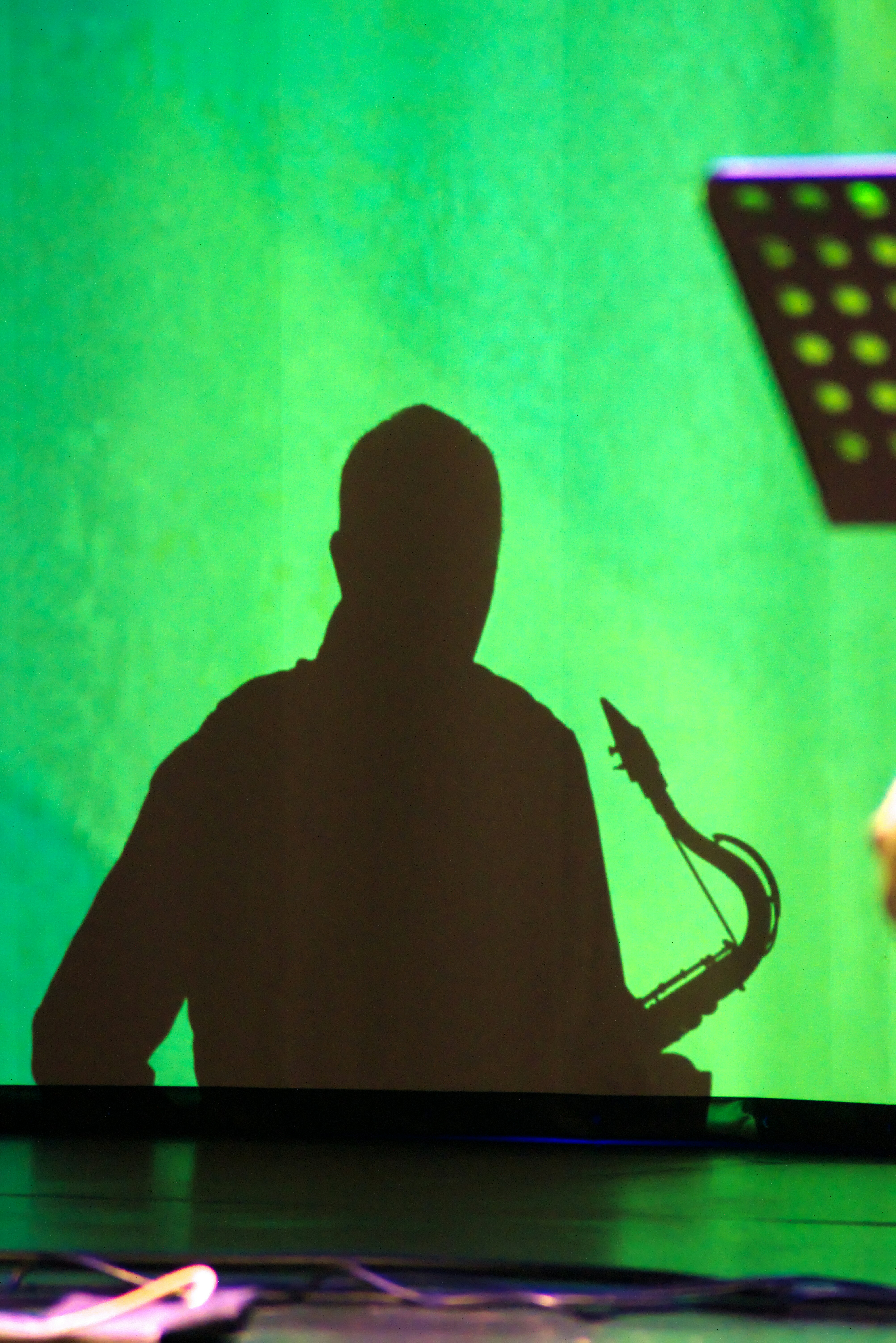 Silhouette of a man playing a saxophone