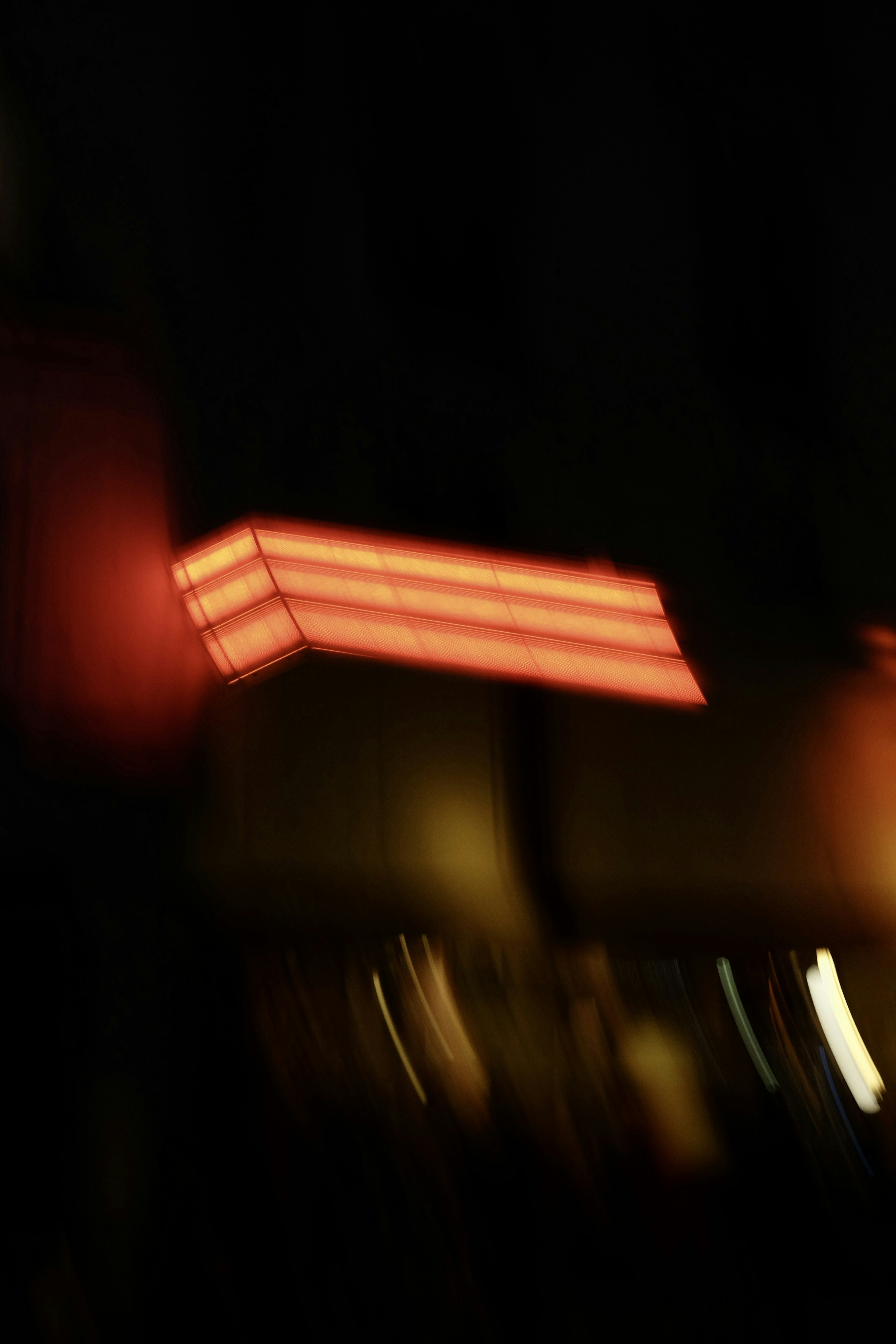 Abstract red light streaks against dark background