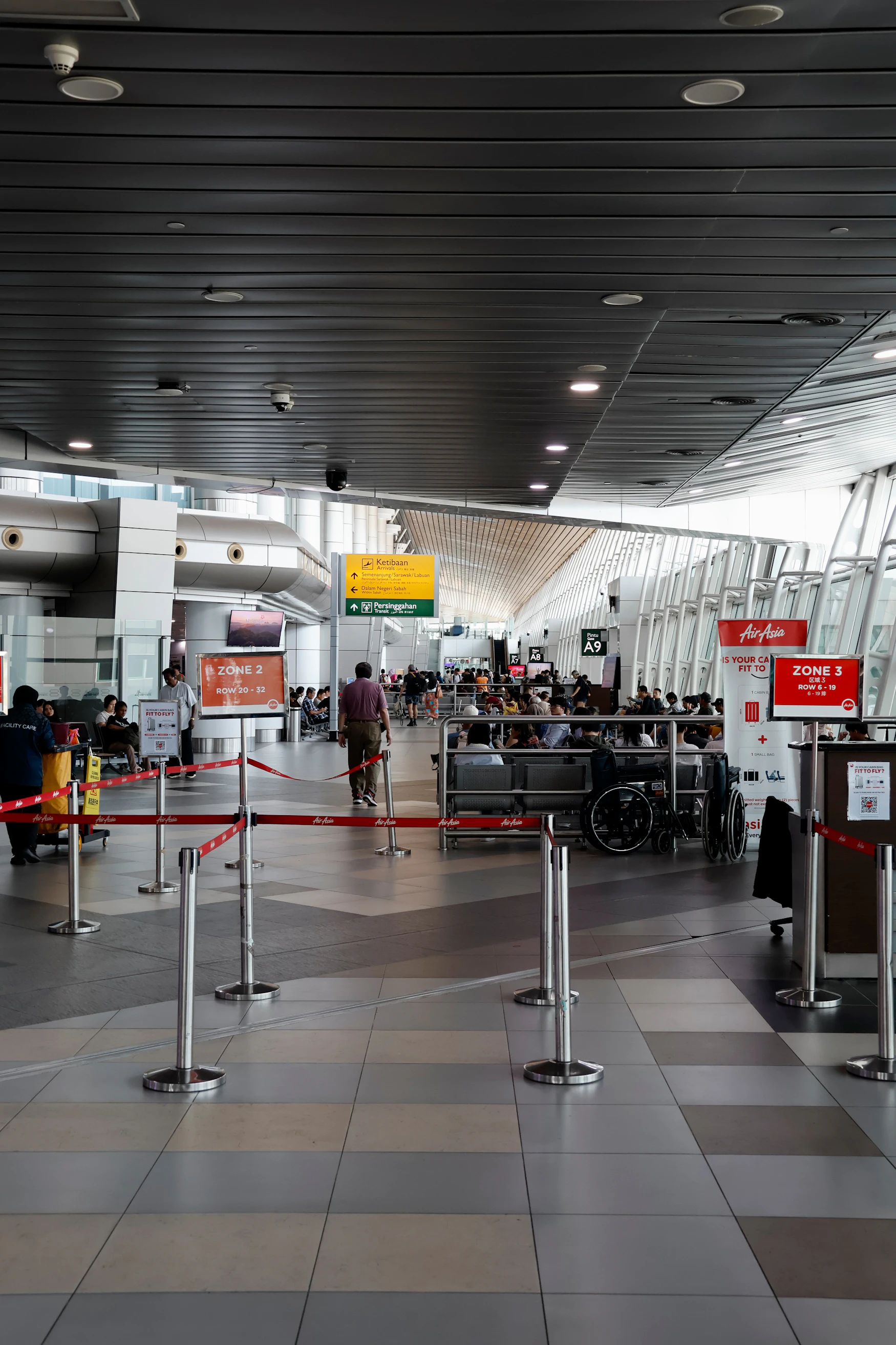 Travelers seated and waiting inside a modern airport terminal
